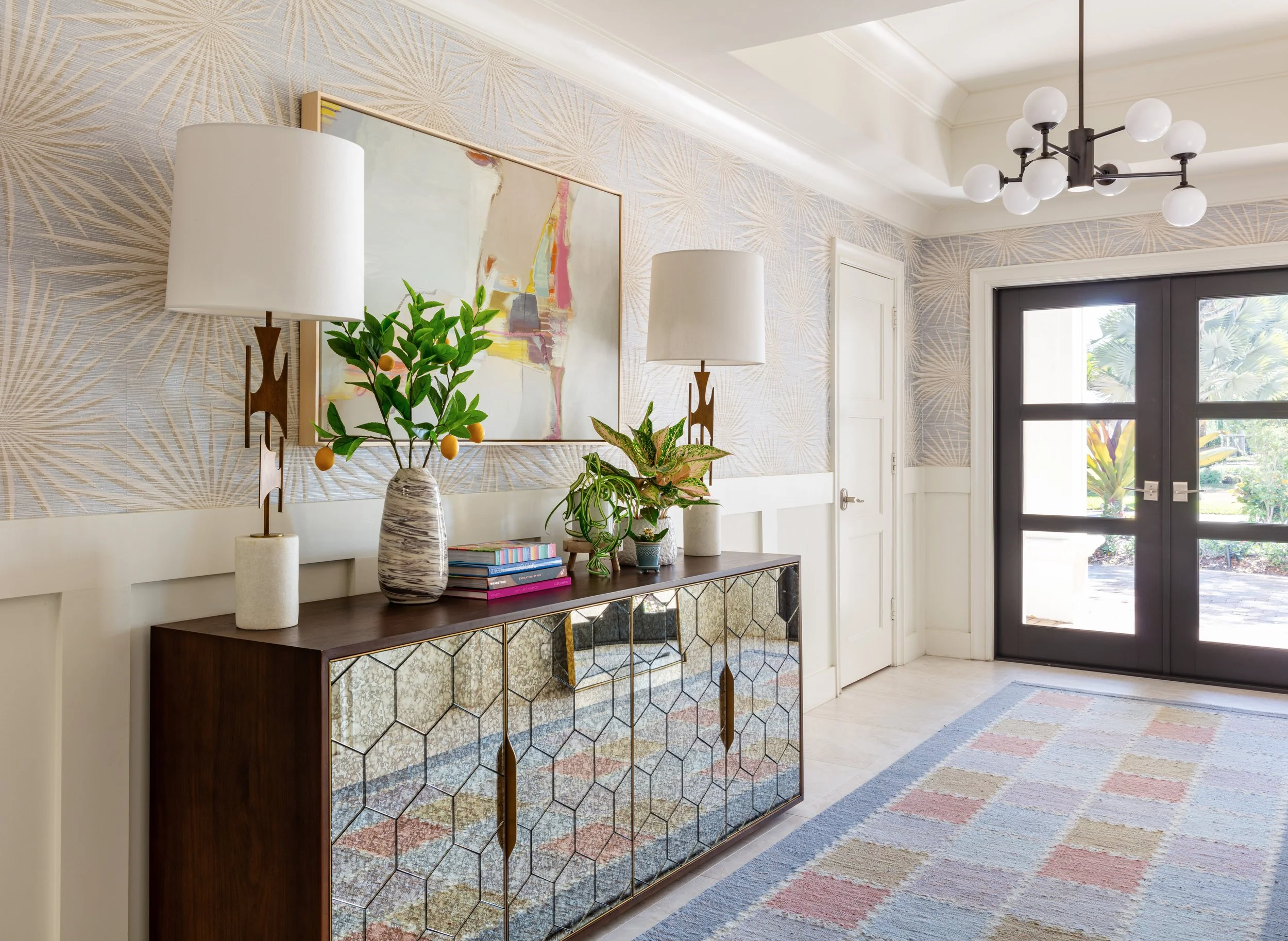 modern-entryway-design-with-stylish-console-table-geometric-mirrored-cabinets-brass-lamps-artistic-vase-colorful-rug-elegant-chandelier-interior-decor-inspiration-for-home.jpg
