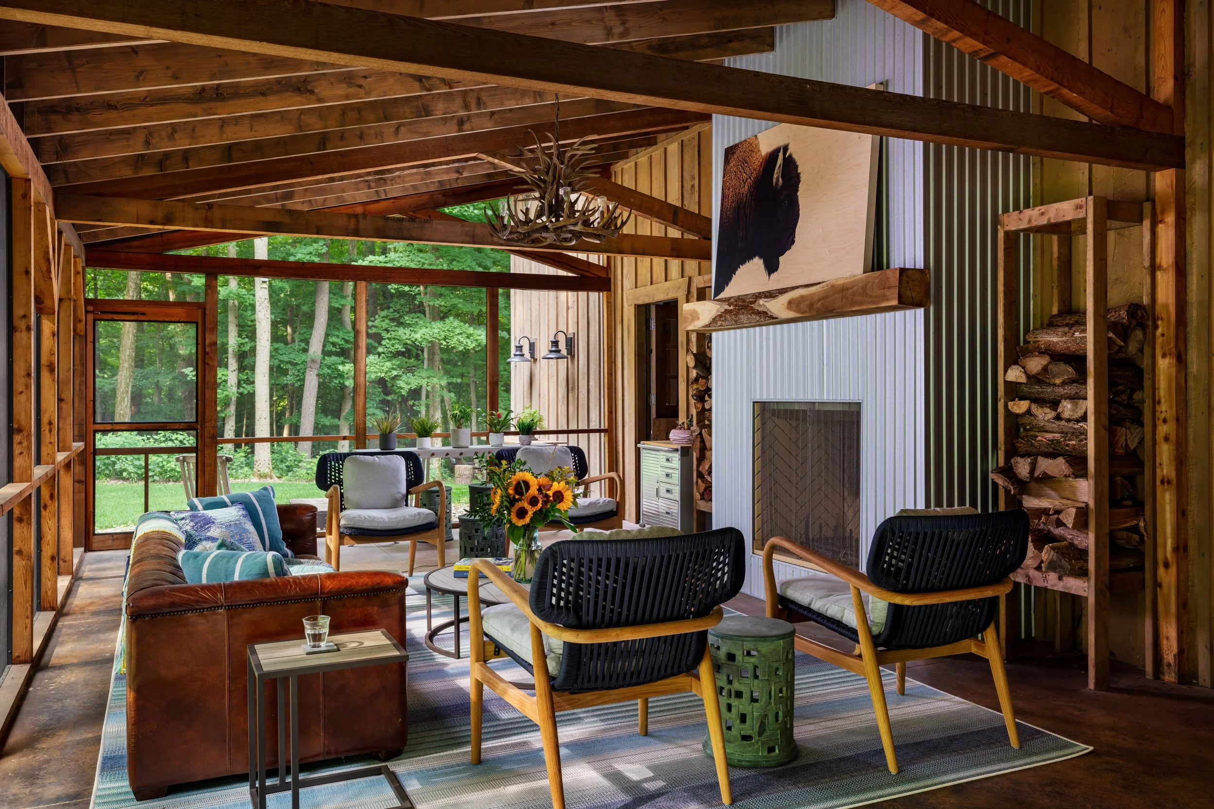 modern screened‑porch living space featuring exposed wooden beams.jpg