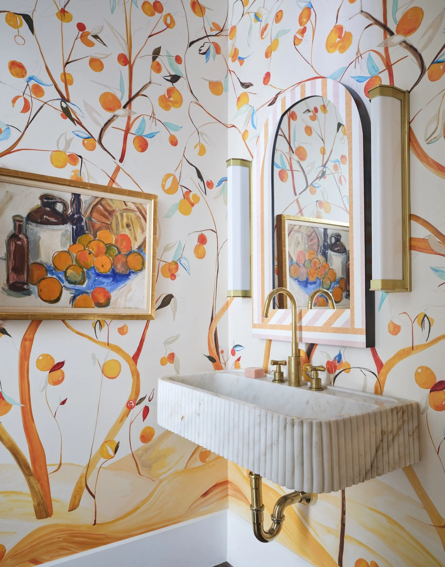 17-whimsical-powder-room-orange-citrus-tree-wallpaper-fluted-marble-sink-striped-mirror-brass-accents-design.jpg