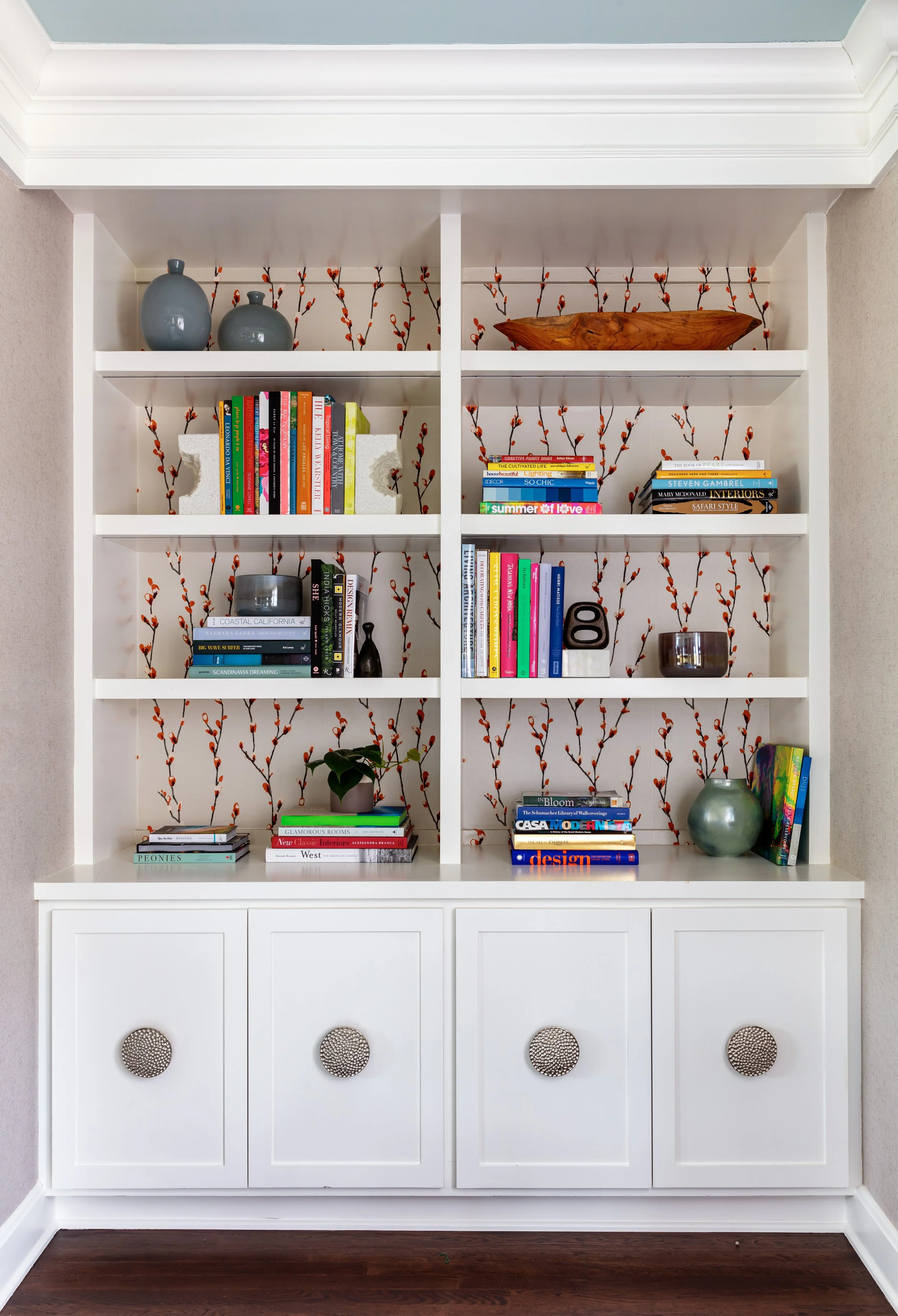 built-in-bookcase-for-family-room-with-wallpaper-behind-shelves.jpg