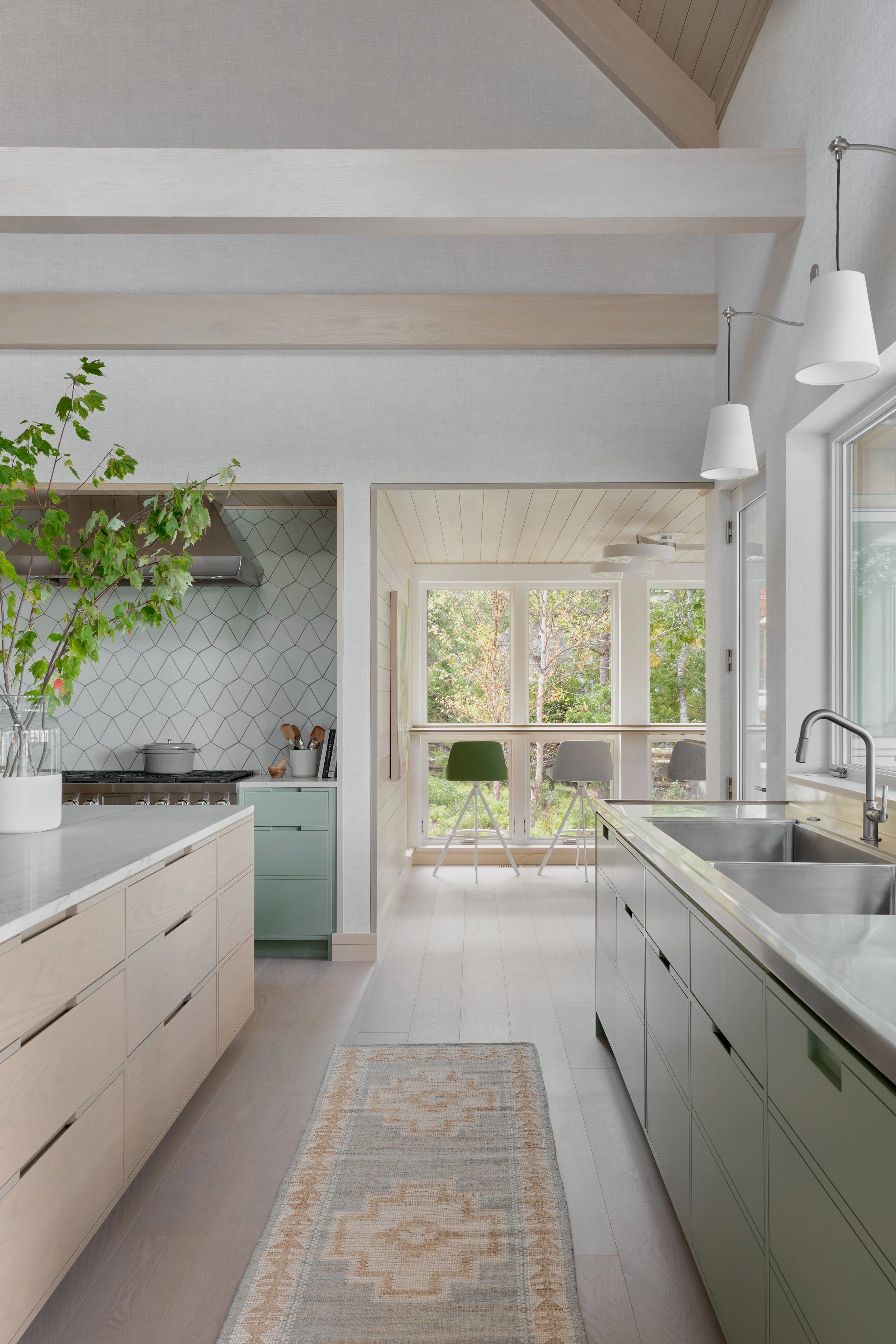 open concept kitchen with neutral color scheme and large windows