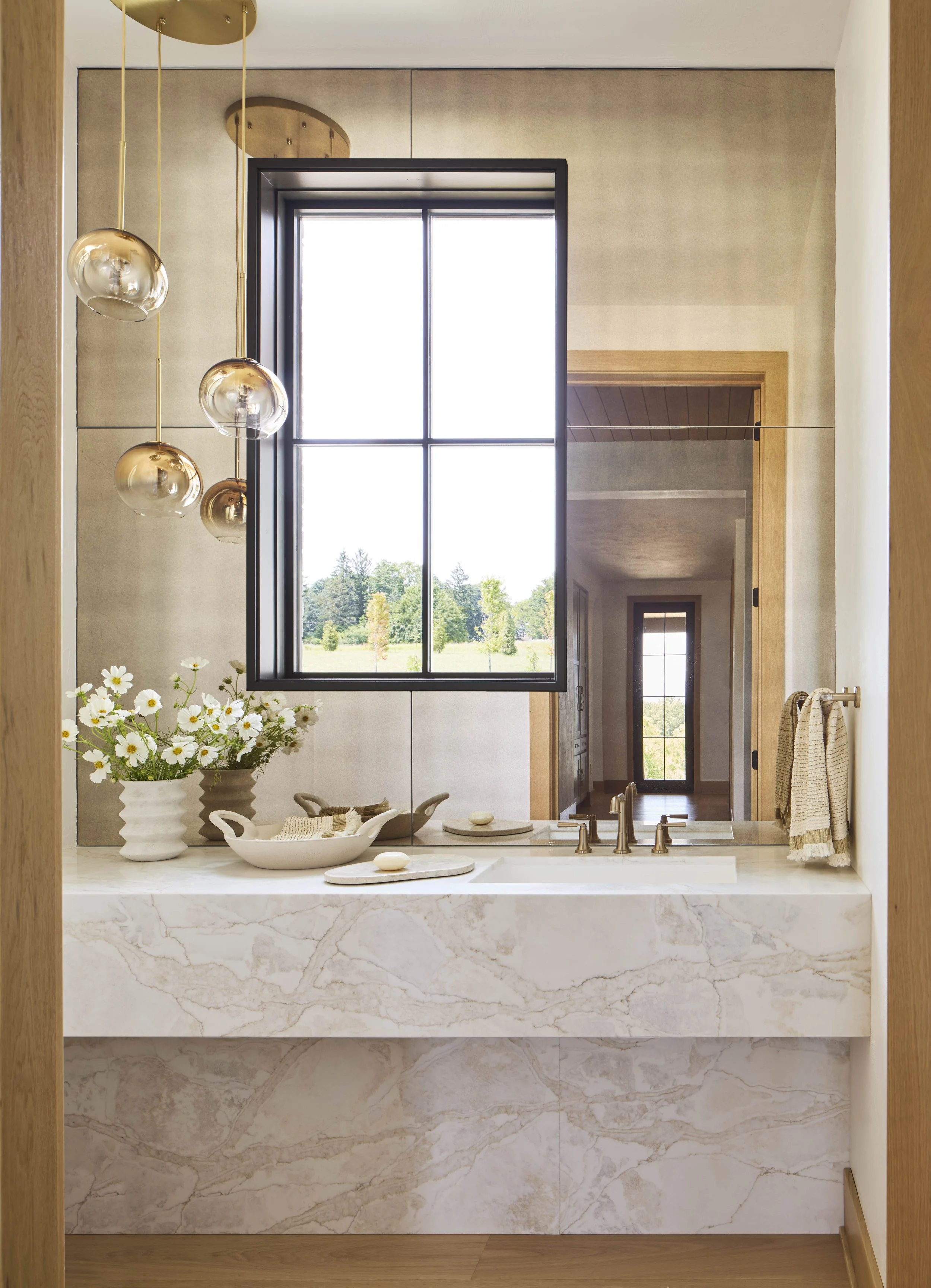 modern-powder-room-with-full-marble-vanity-and-statement-lighting.jpg