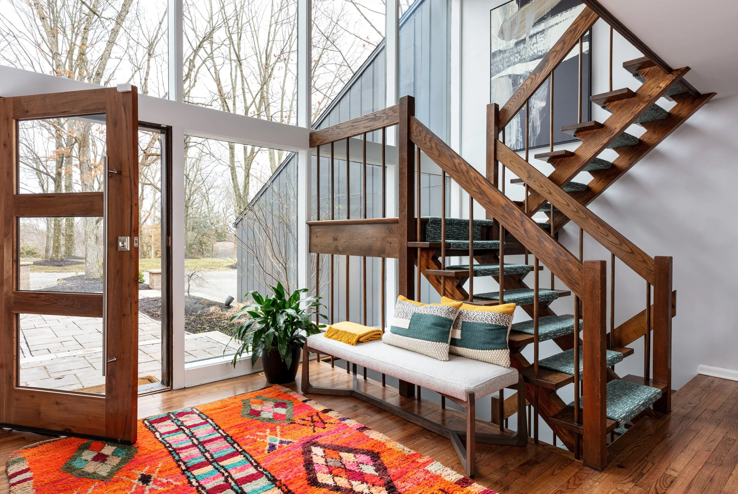 modern-entry-with-glass-windows-open-staircase.jpeg