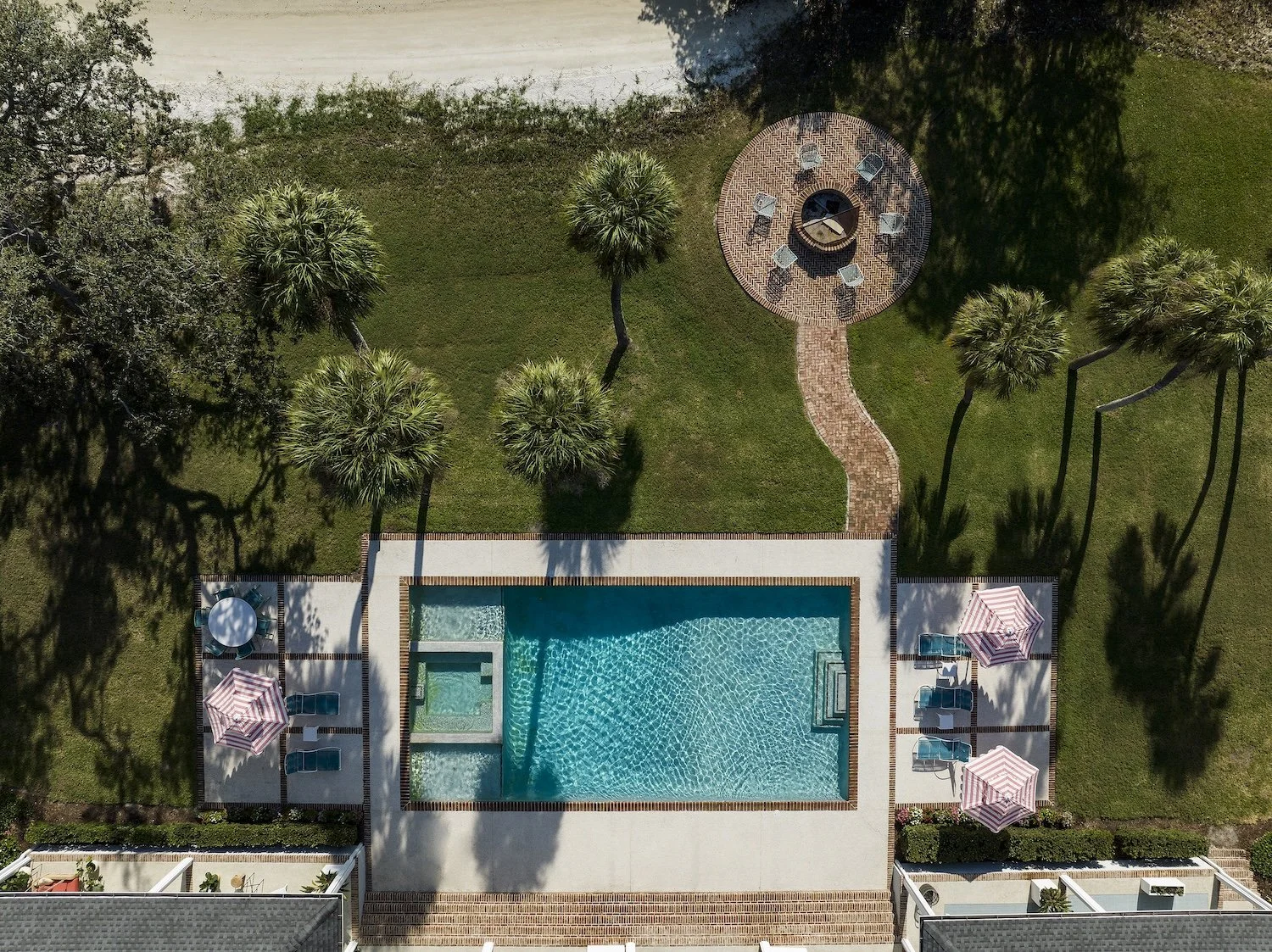 77-aerial-view-florida-backyard-pool-patio-firepit-brick-walkway-palm-trees-lush-landscape-design.jpg