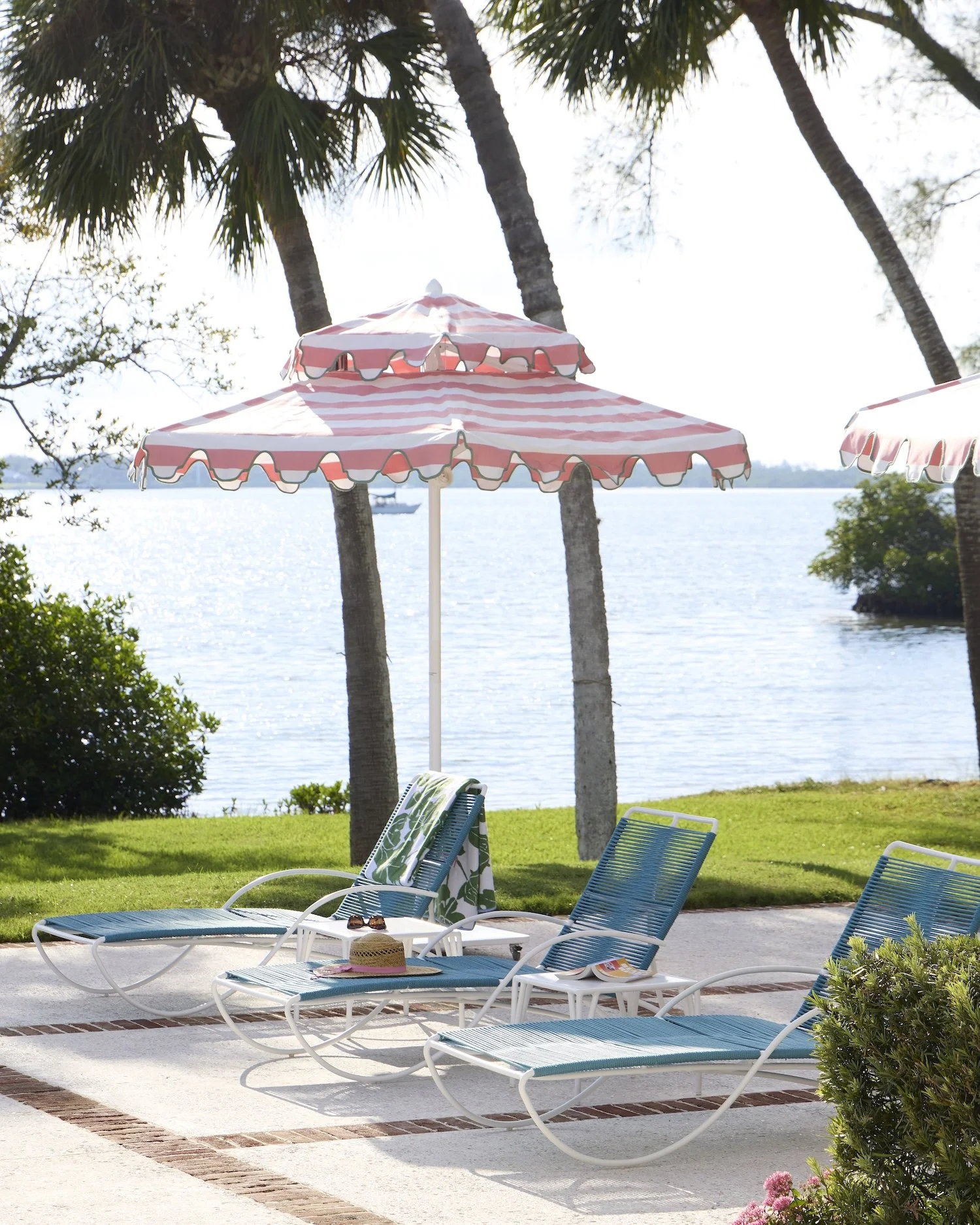 58-poolside-lounge-chairs-waterfront-pink-umbrellas-palm-trees-luxurious-outdoor-living-design.jpg