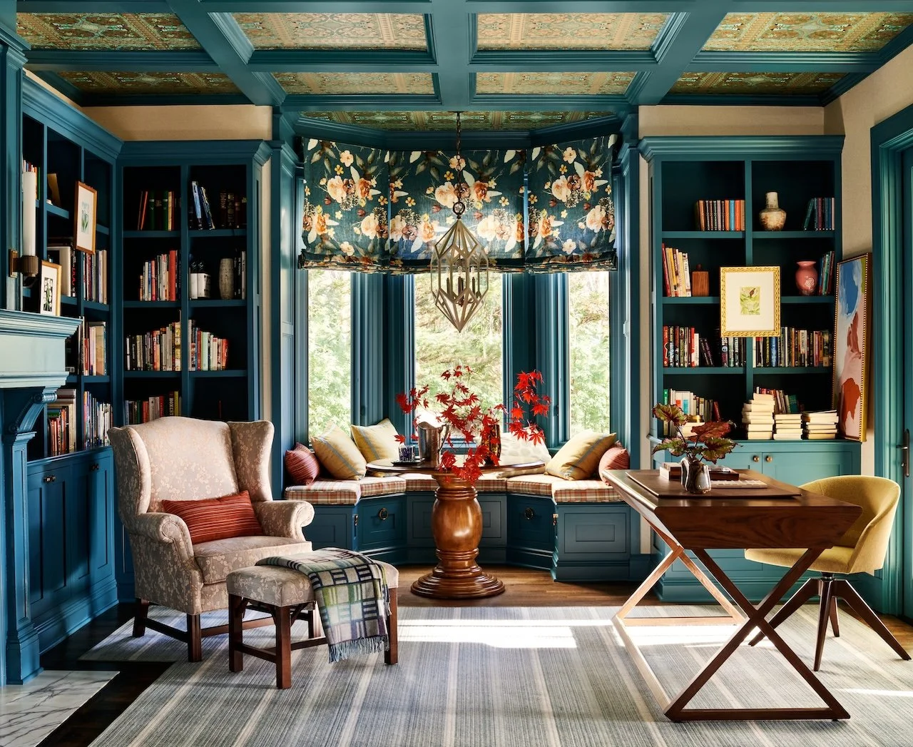 home-office built-in-bookshelves patterned coffered ceiling floral roman shades window