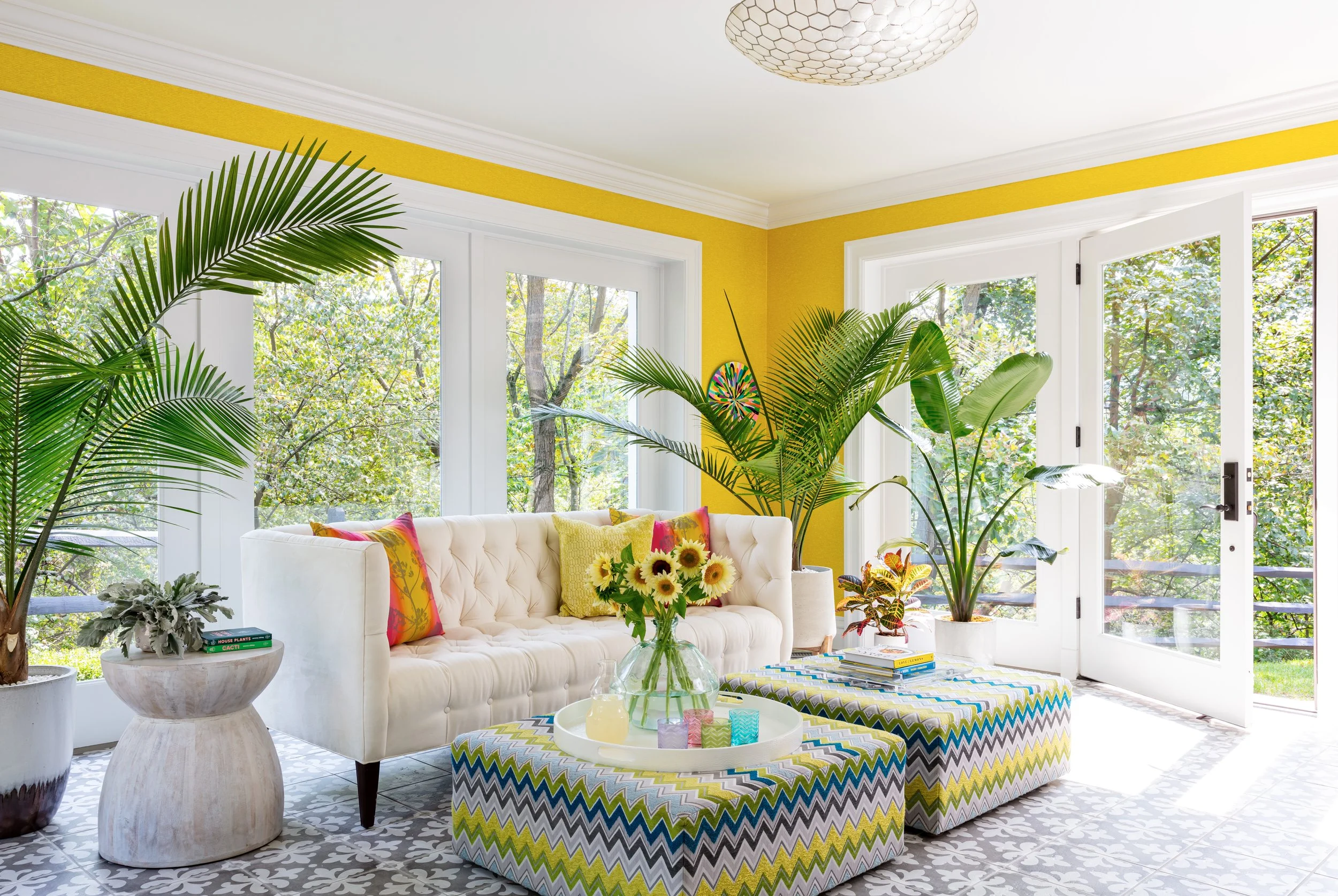 bright-cheery-sunroom-with-comfortable-seating-and.-large-ottomans.jpg