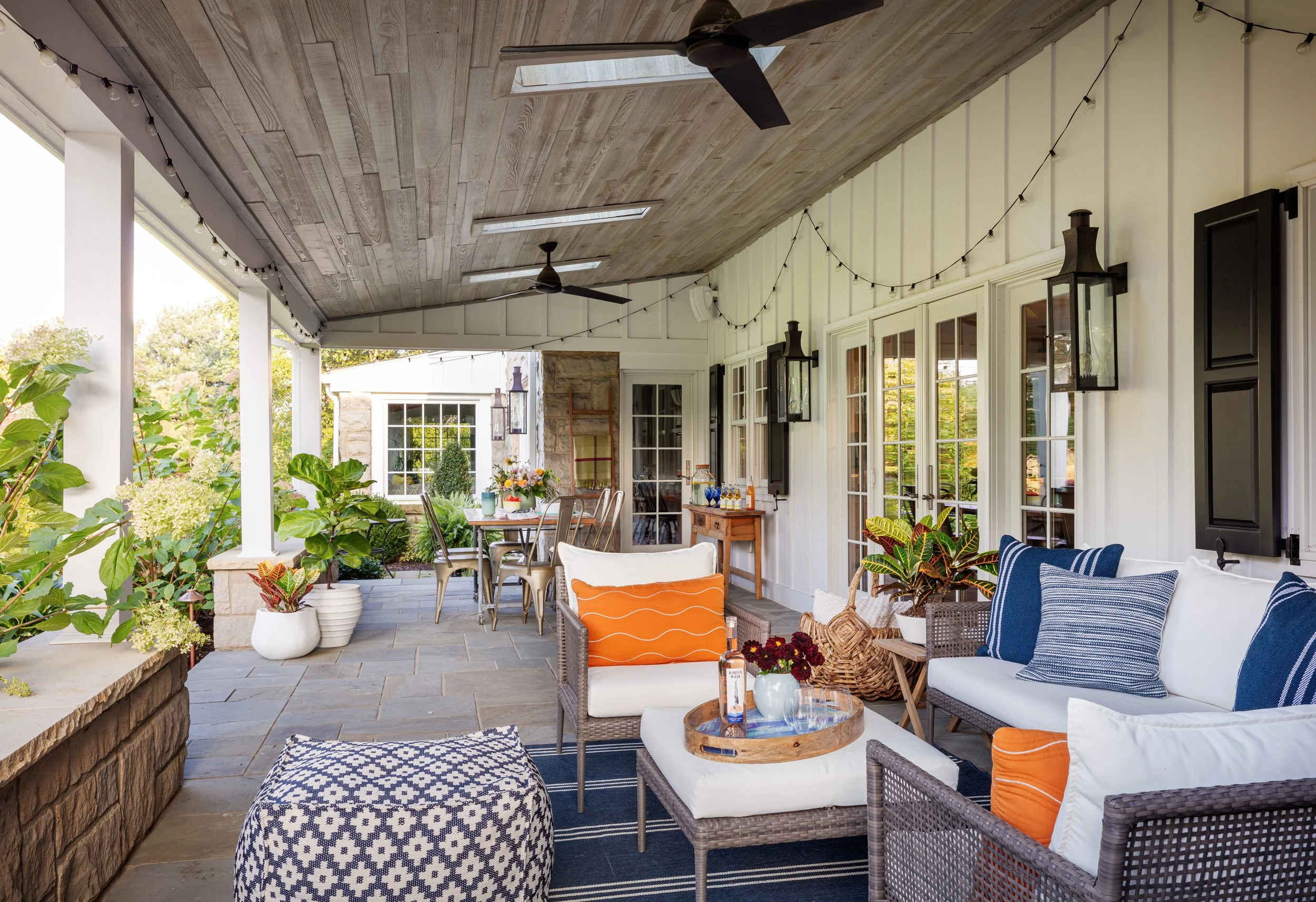 Elegant outdoor patio design with rustic wooden ceiling, comfortable seating, string lights for stylish alfresco entertaining spaces modern home décor