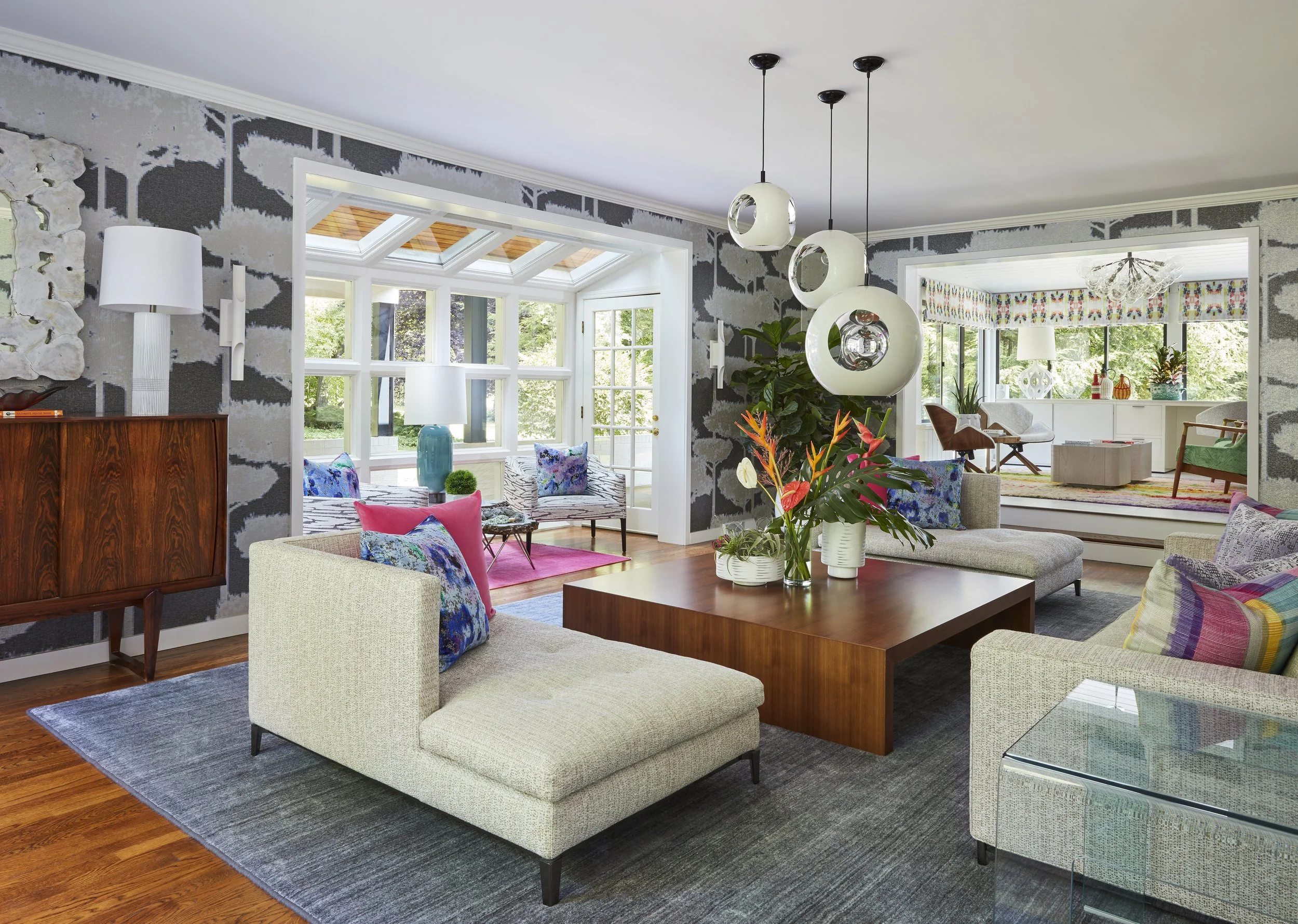 modern living room with gray wallpaper abstract art acrylic tables white sofas colorful pink blue pillows stylish lounge modern design interior 

