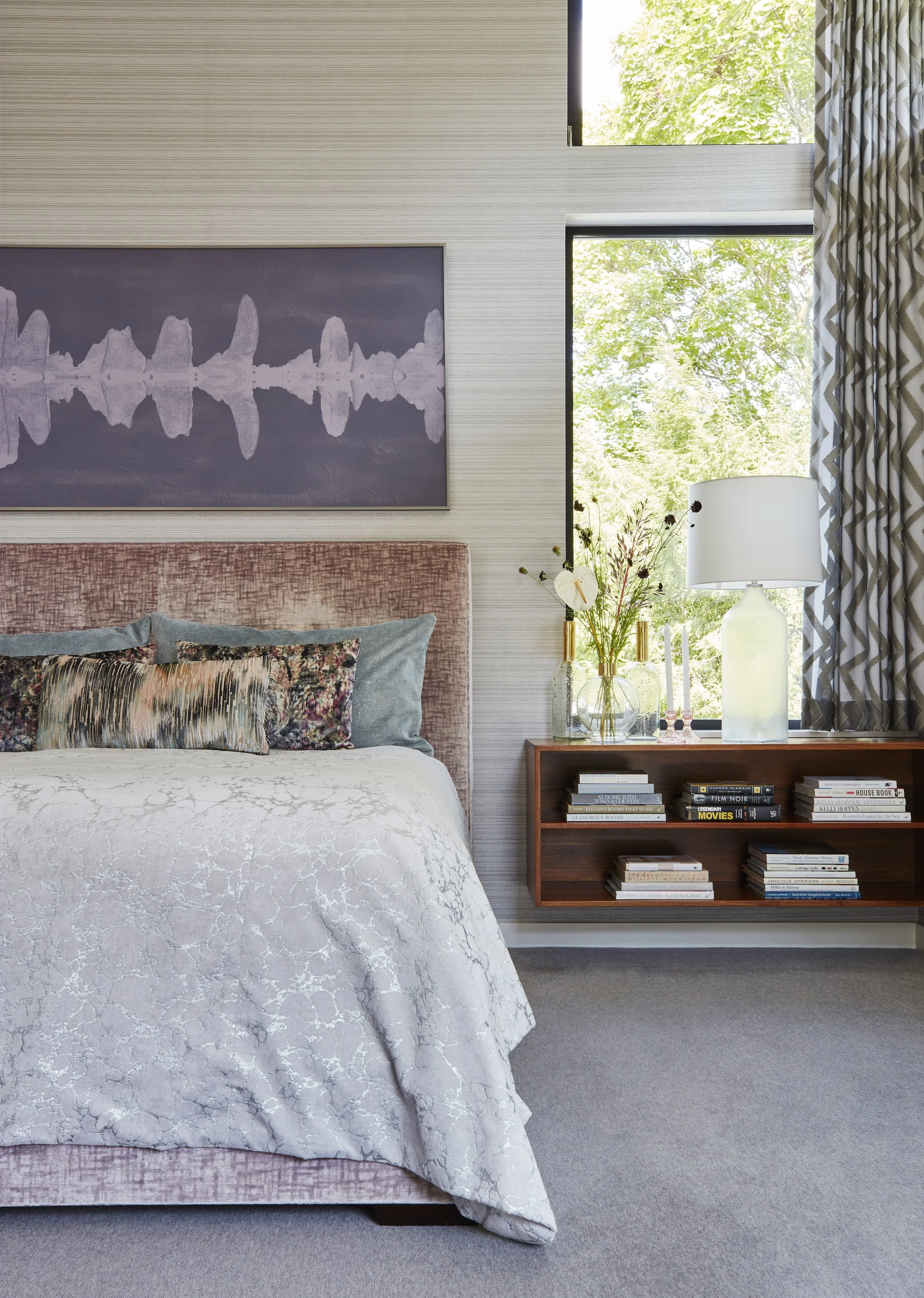 modern bedroom with soft pink bed cozy bedding floating nightstand and abstract art