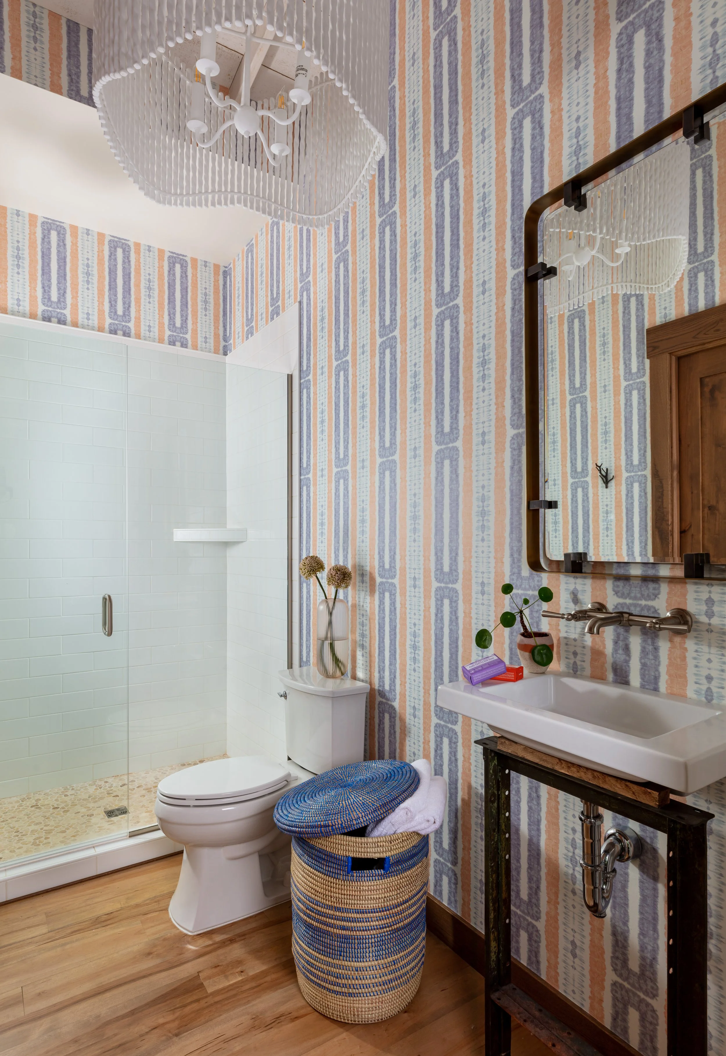 Elegant‑bathroom‑design‑with‑striped‑peach‑and‑blue‑wallpaper‑crystal‑chandelier‑and‑rustic‑wood‑floor‑for‑modern-interiors.jpg
