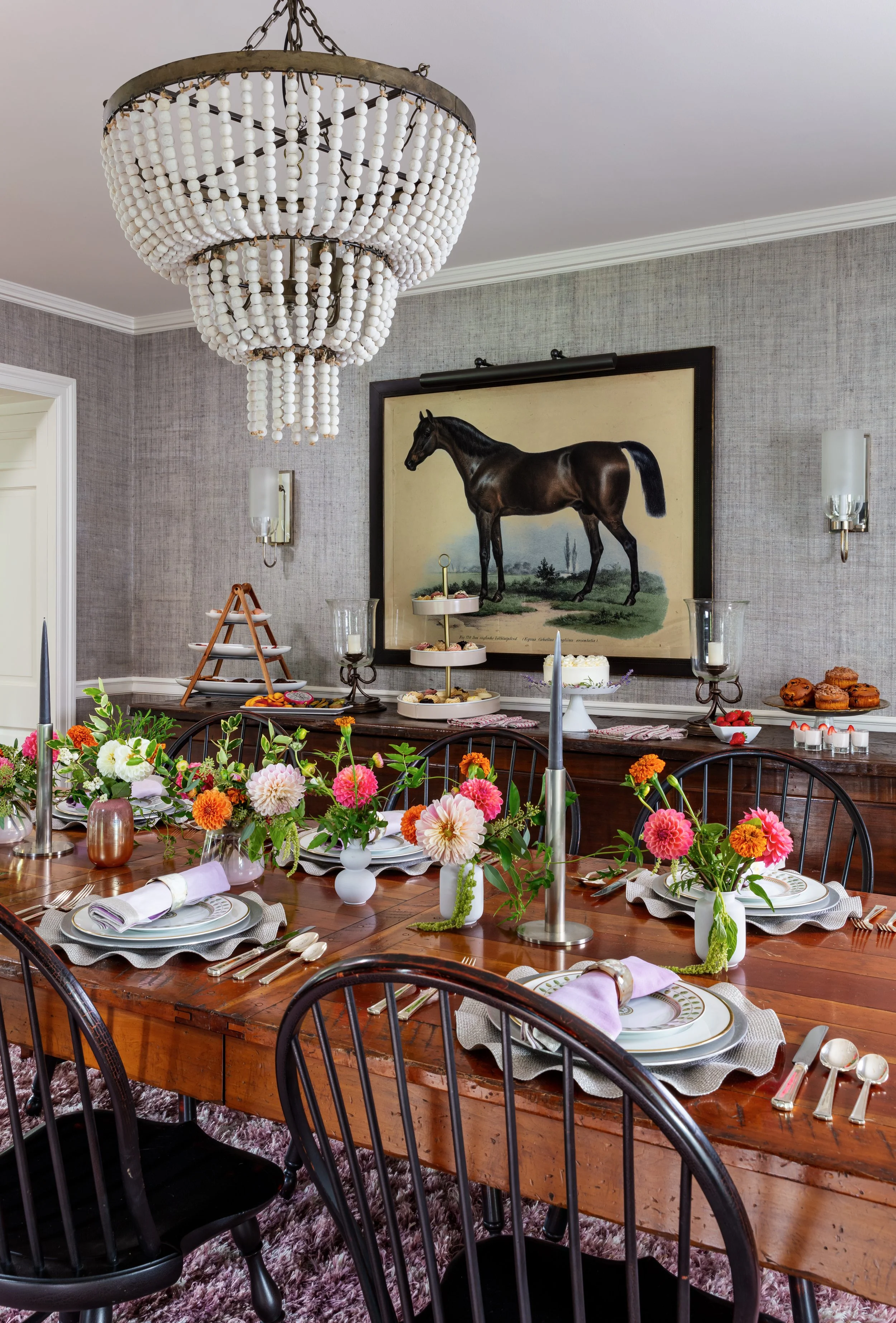 traditional dining table with beaded chandelier textured wallpaper serving buffet