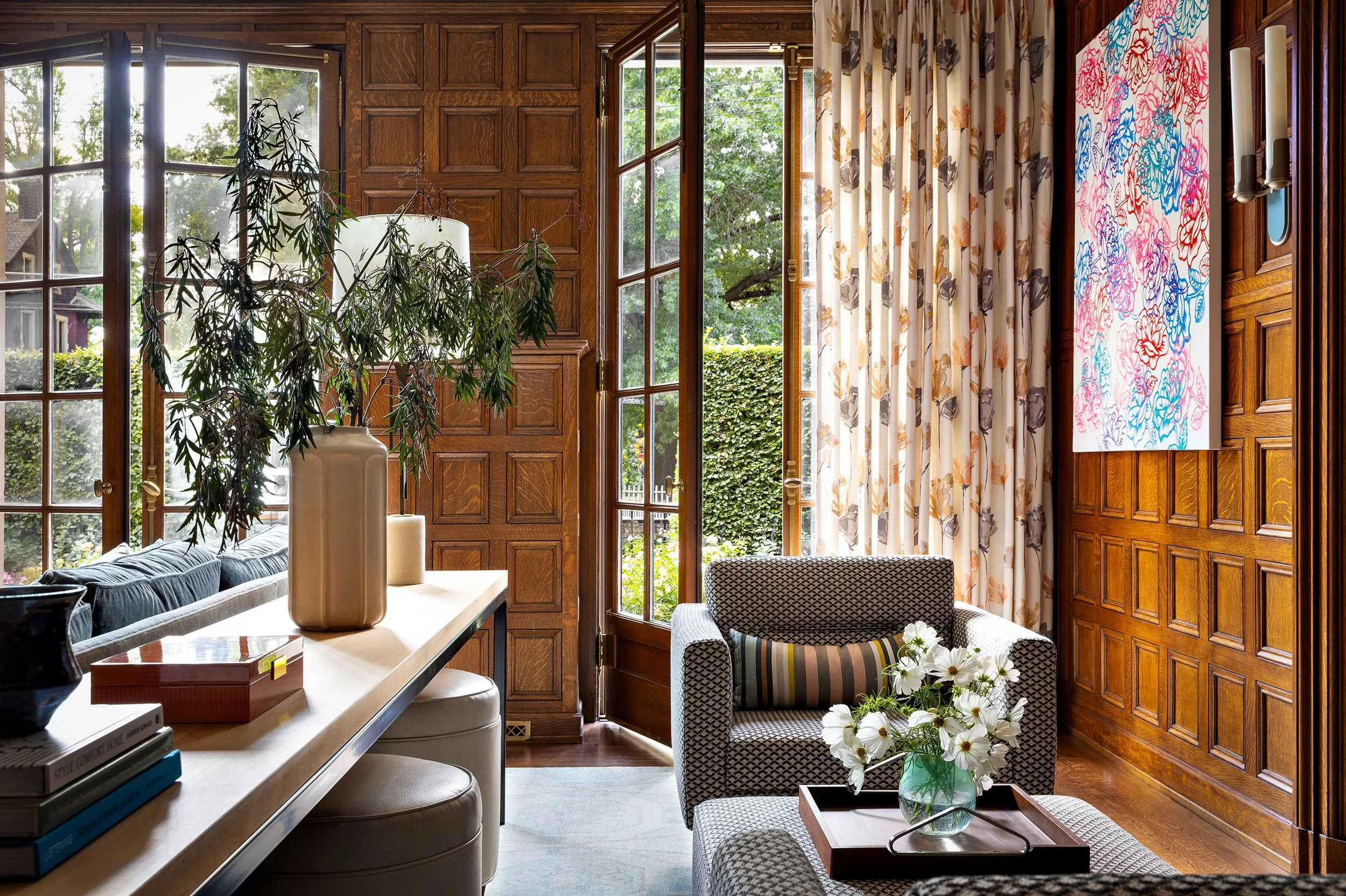 cozy living room lounge chair with coffee table books and colorful art