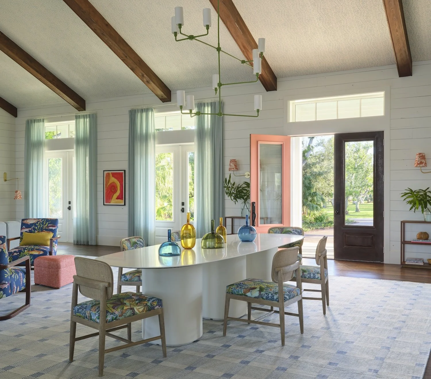5-florida-home-dining-living-room-exposed-beams-pink-door-colorful-furniture-vibrant-interior-design-modern-charm.jpg