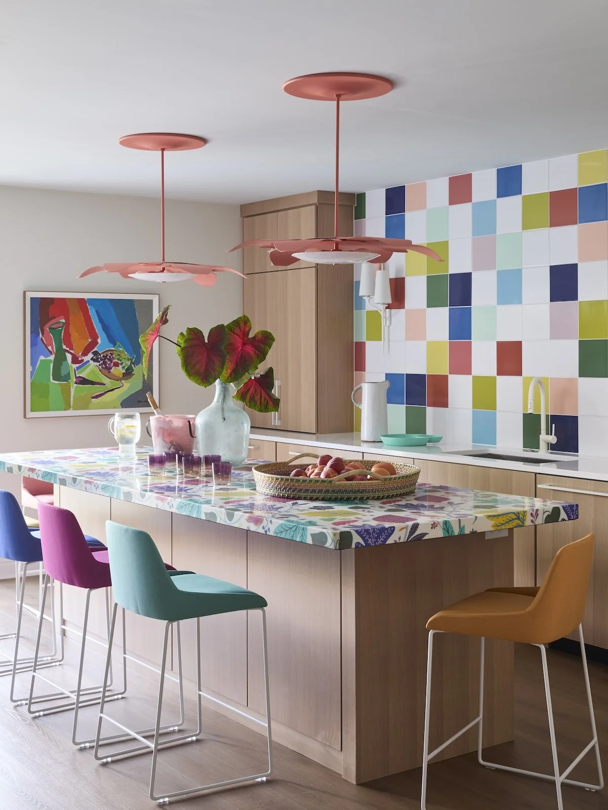 fun gameroom island with floral mosaic countertop, multicolor checkered tile backsplash, bright velvet bar stools by Betsy Wentz interior design