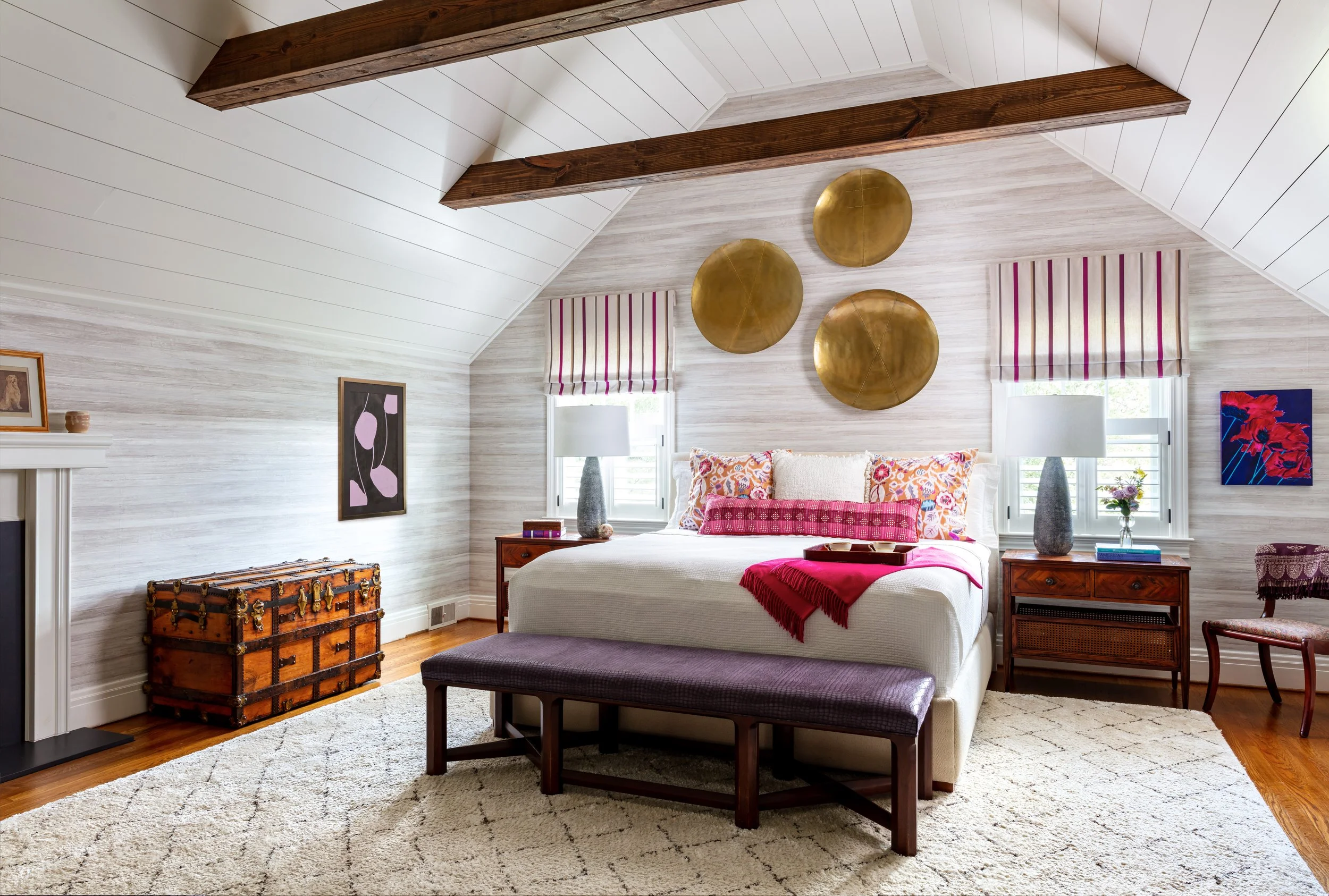 farmhouse bedroom with neutral bed rug cozy bedding purple bench and roman shades