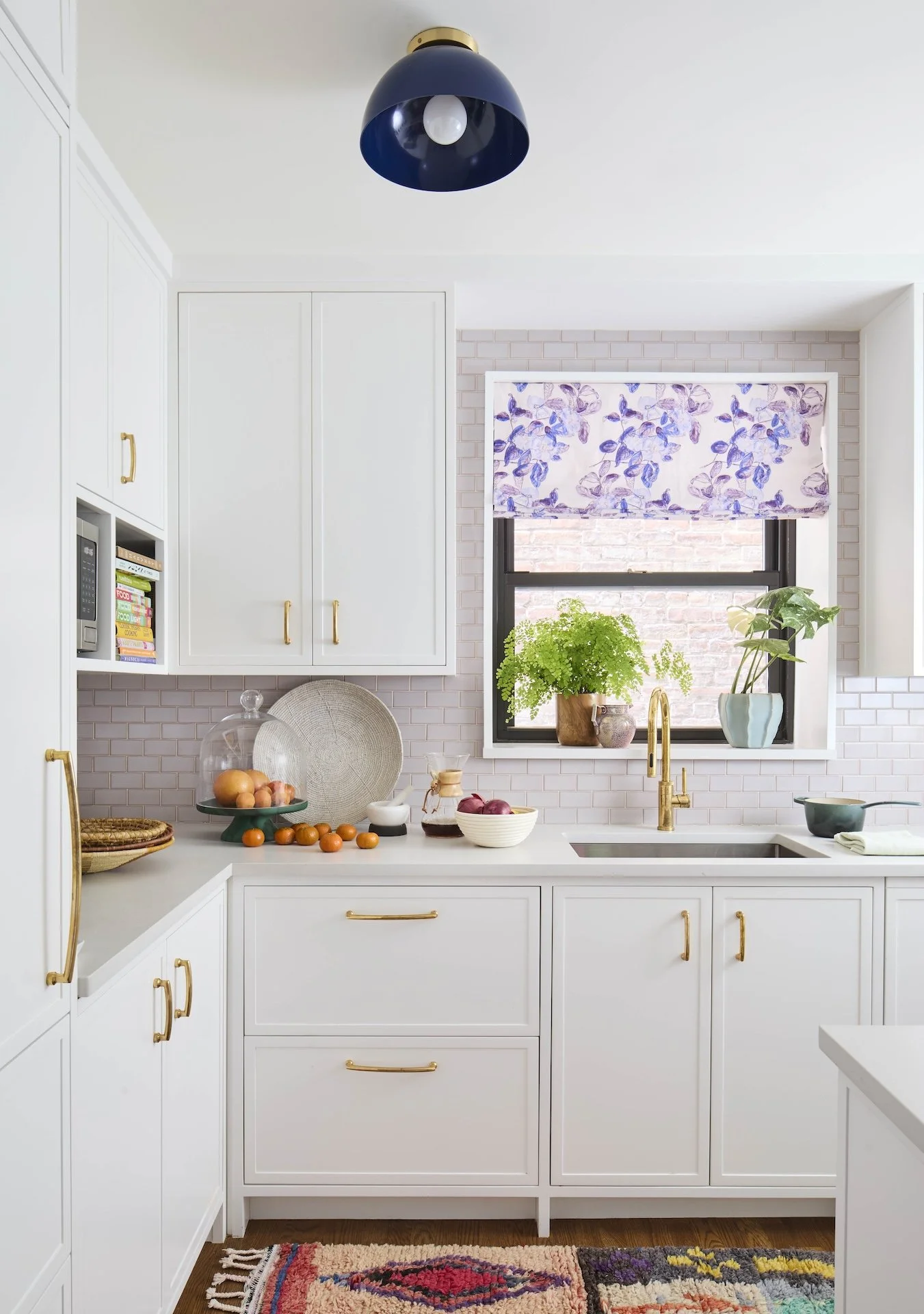 Sleek small space modern kitchen white cabinets floral shade statement light