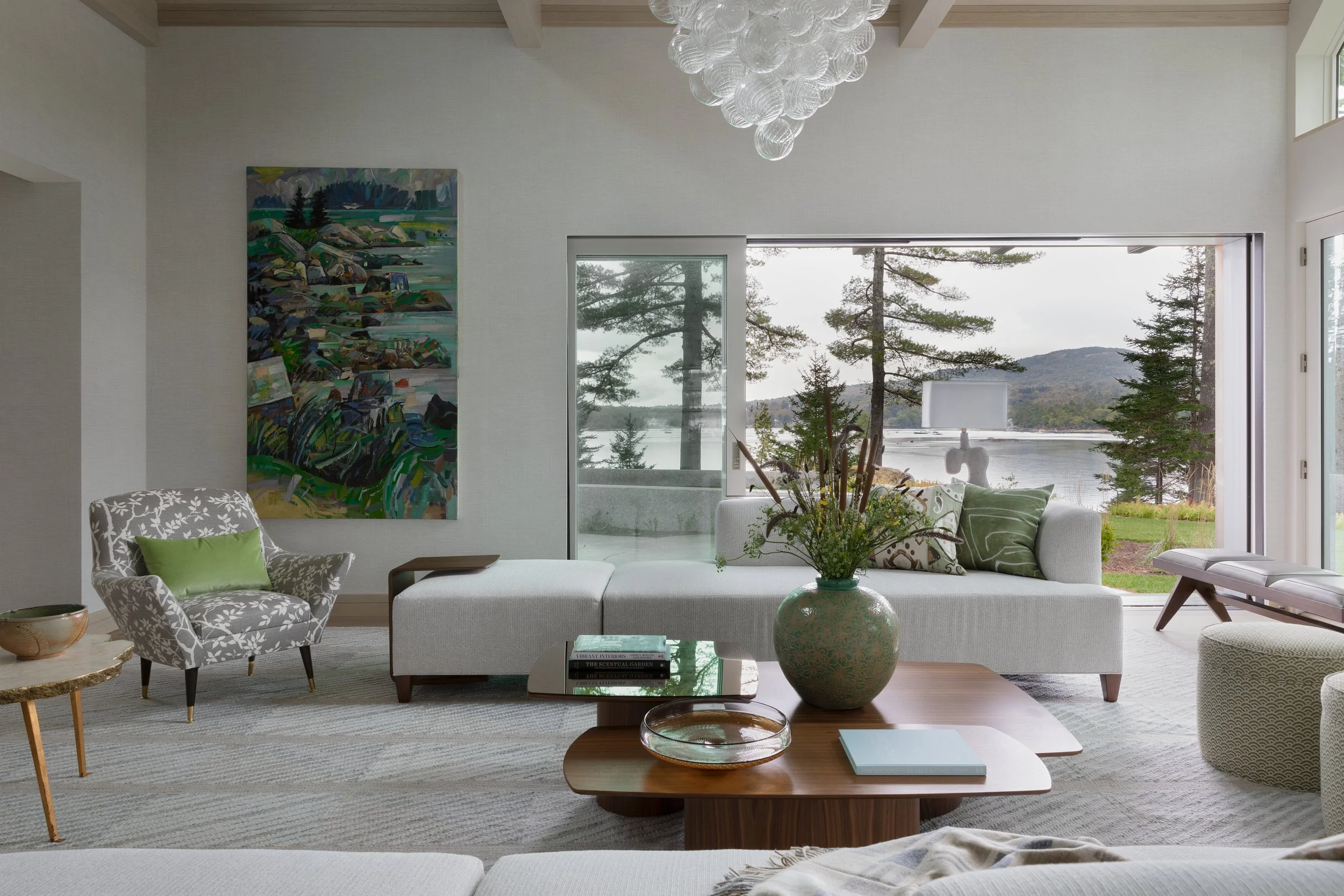 living room with modern sofa wood coffee table bubble chandelier and statement windows