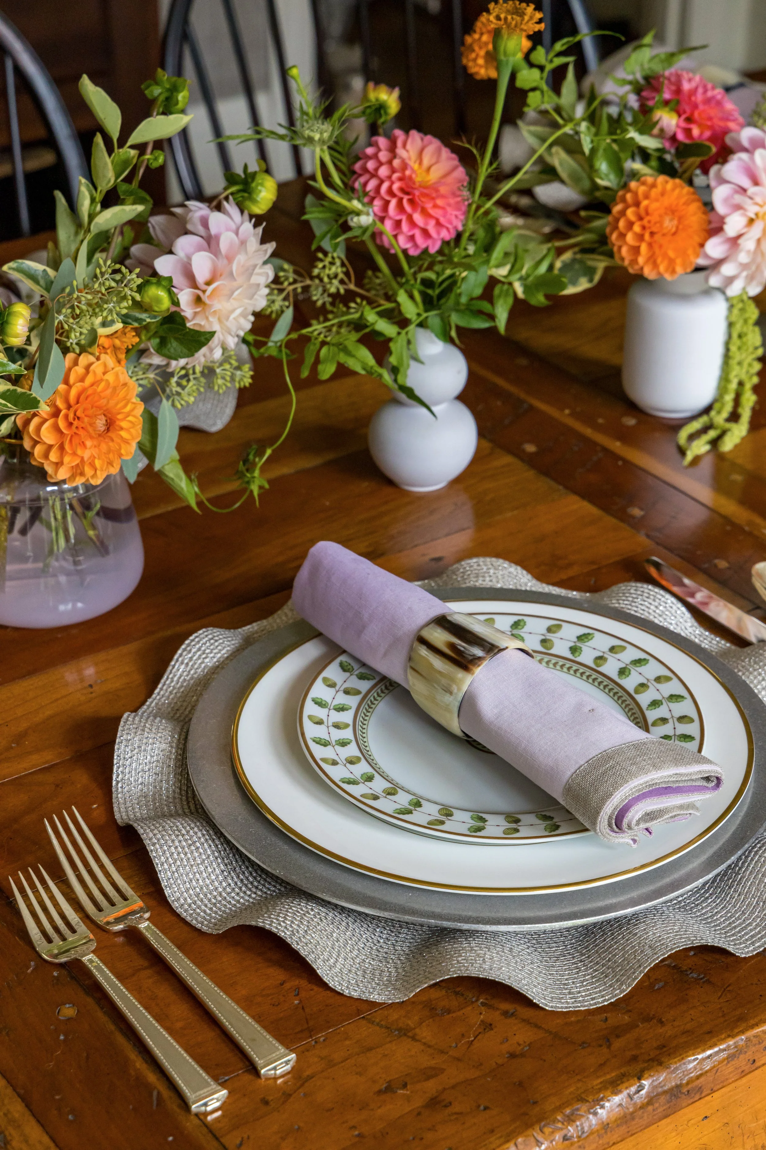 traditional table setting with dishes silverware and flowers
