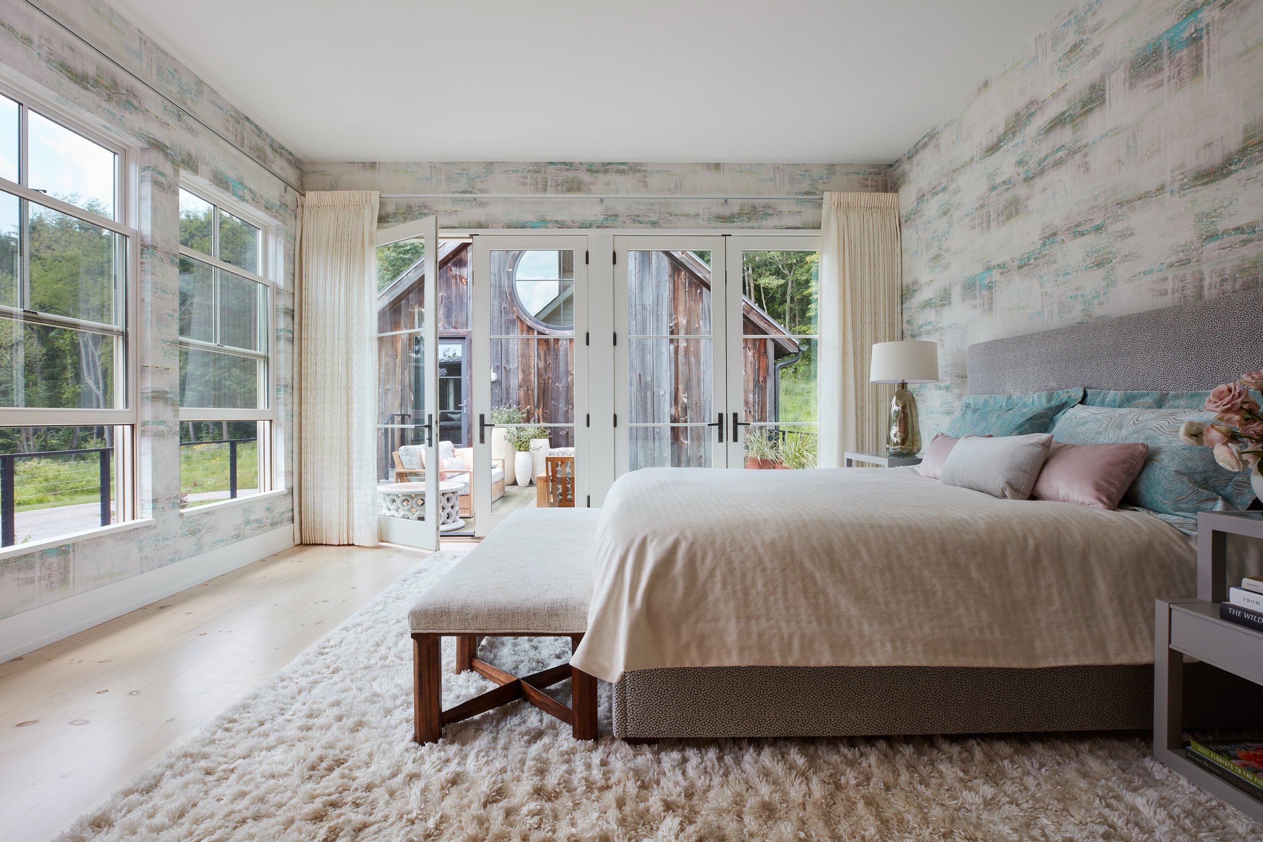 modern-bedroom-with-textured-wallpaper-french-doors-light-wood-floors-plush-rug-neutral-bedding-pink-teal-pillows-brushed-metal-lamp-farmhouse-style-design-inspiration.jpg