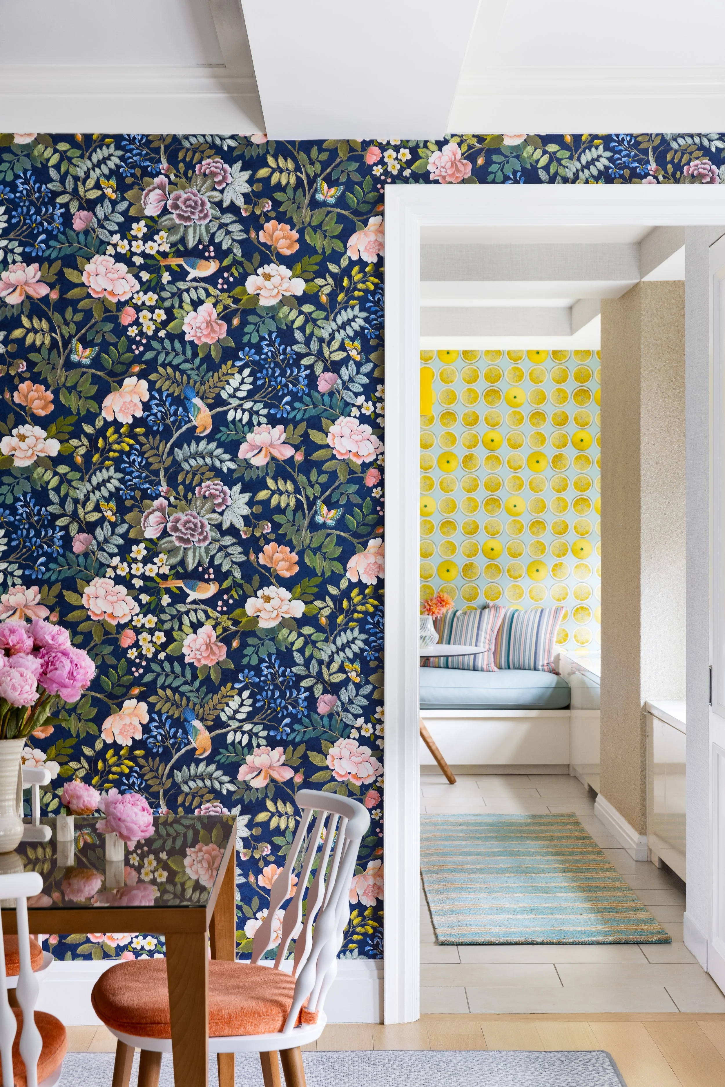 floral wallpaper in dining room with complimentary lemon wallpaper in kitchen