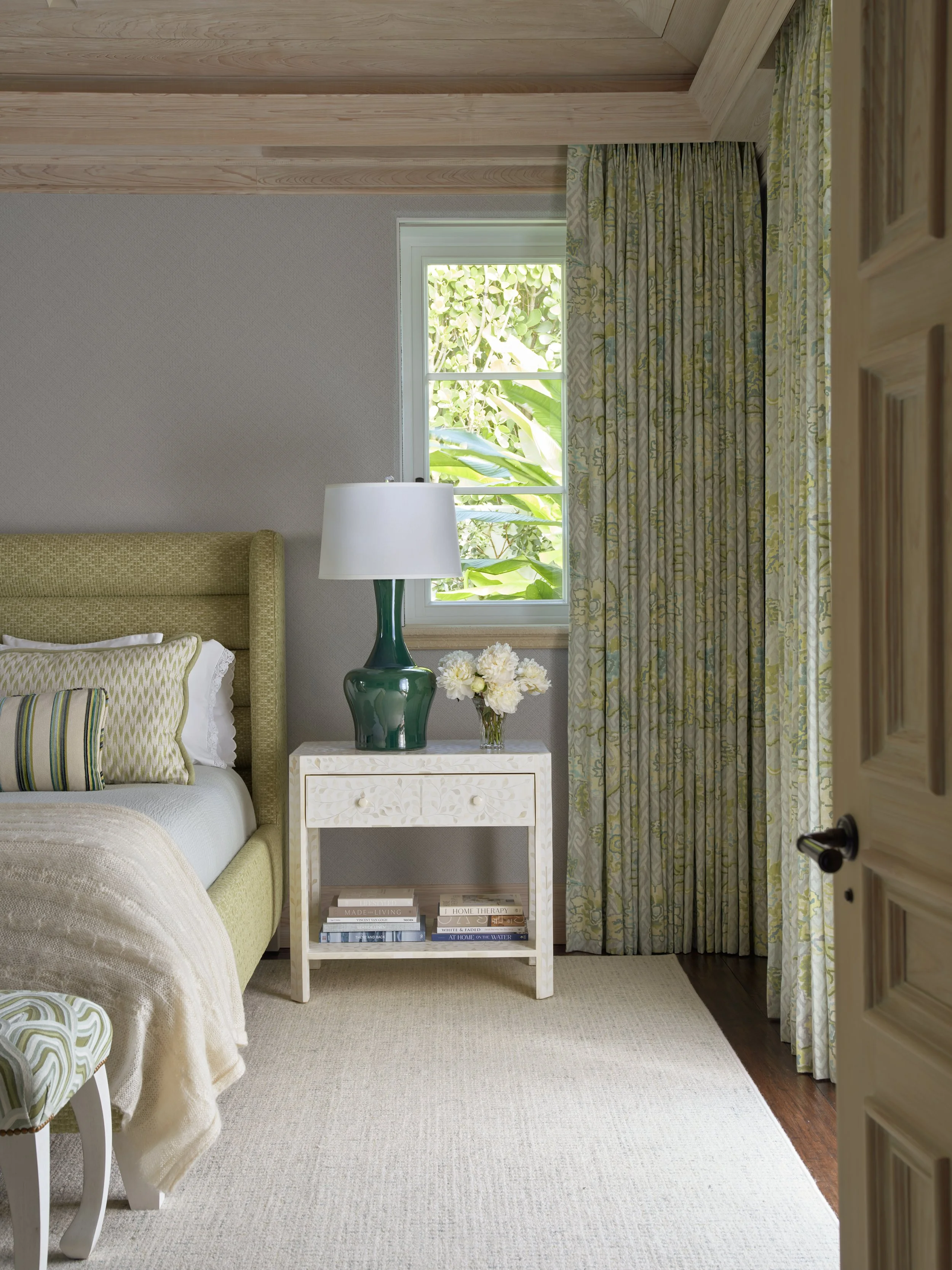 bedroom interior design with textured headboard patterned curtains coordinated pillows elegant nightstand lamp modern home décor