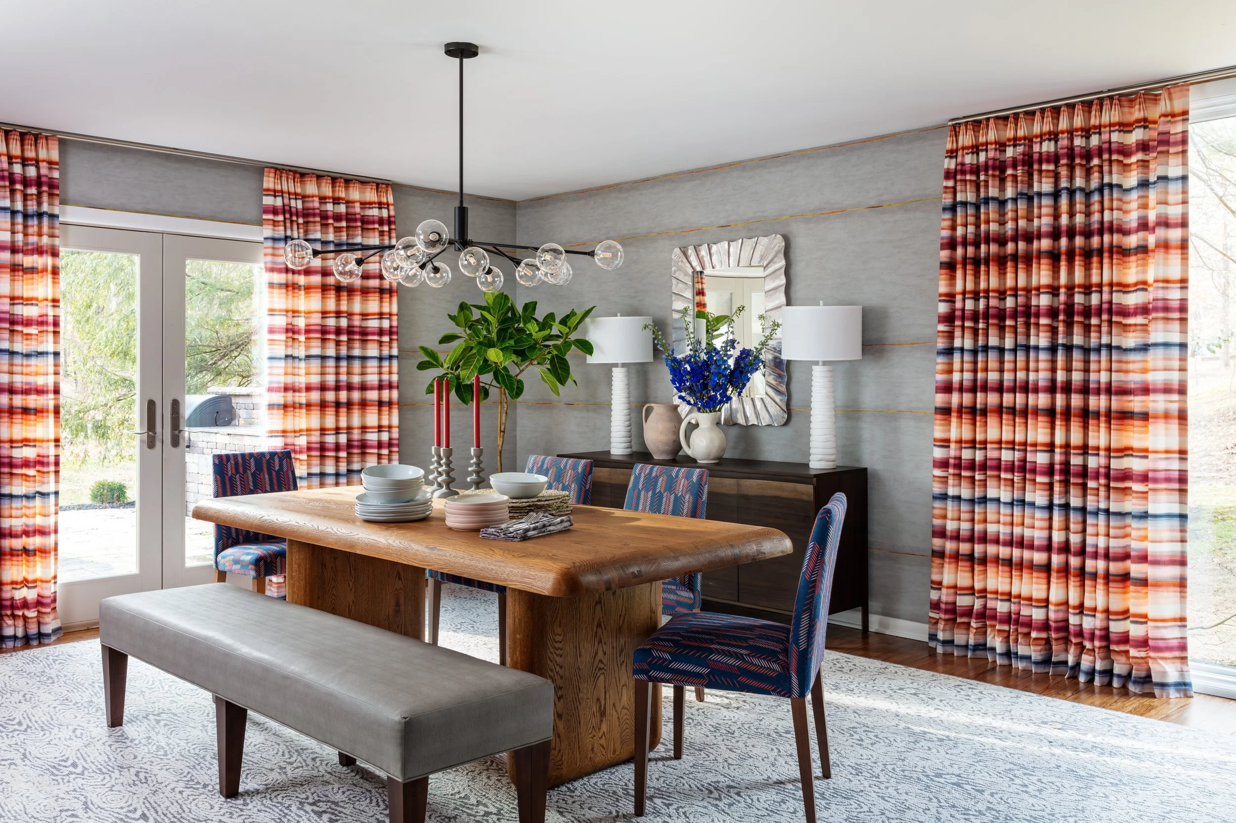 modern-dining-room-with-colorful-drapery-and-statement-lighting.jpeg