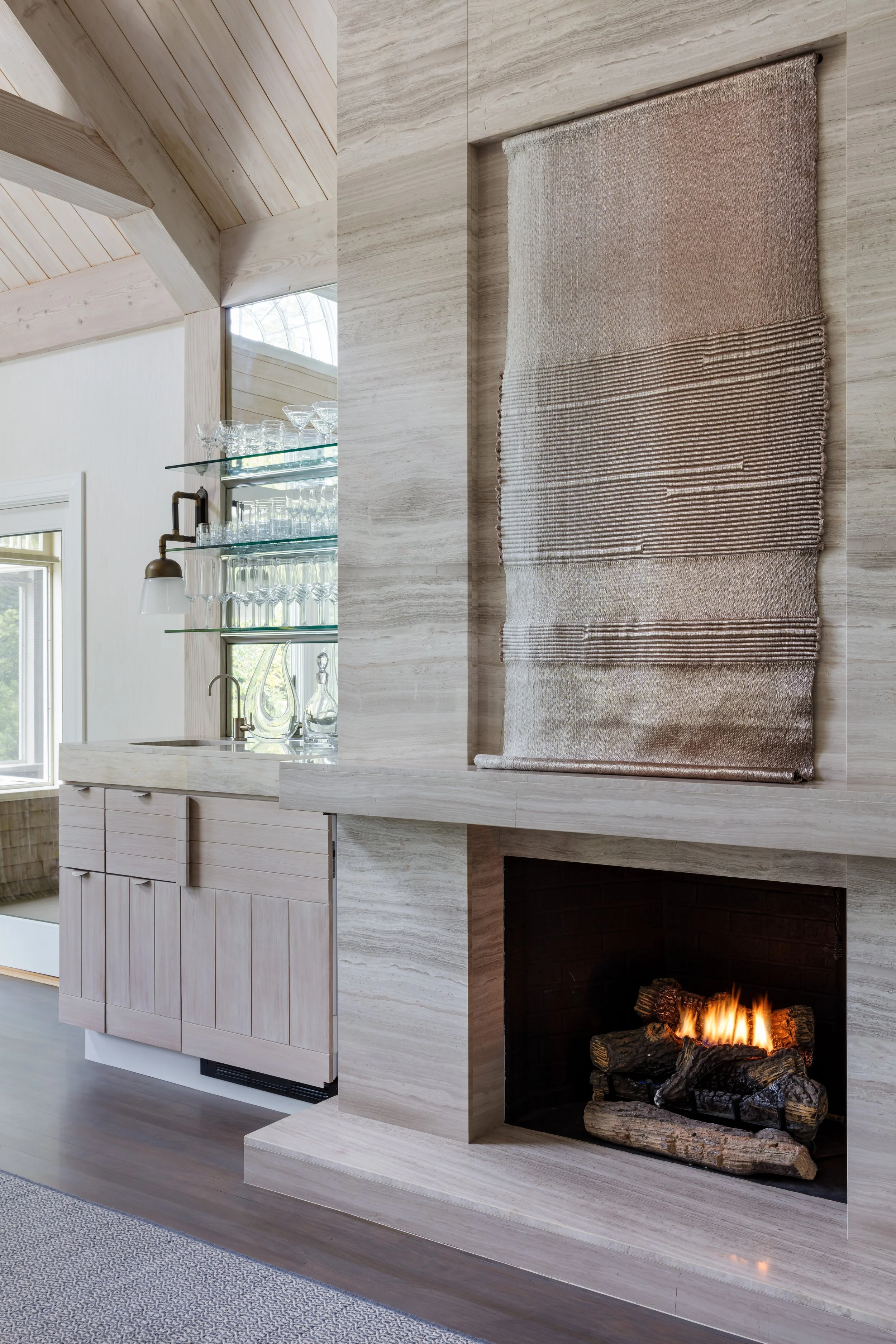 modern minimalist fireplace with light gray concrete surround and textured art