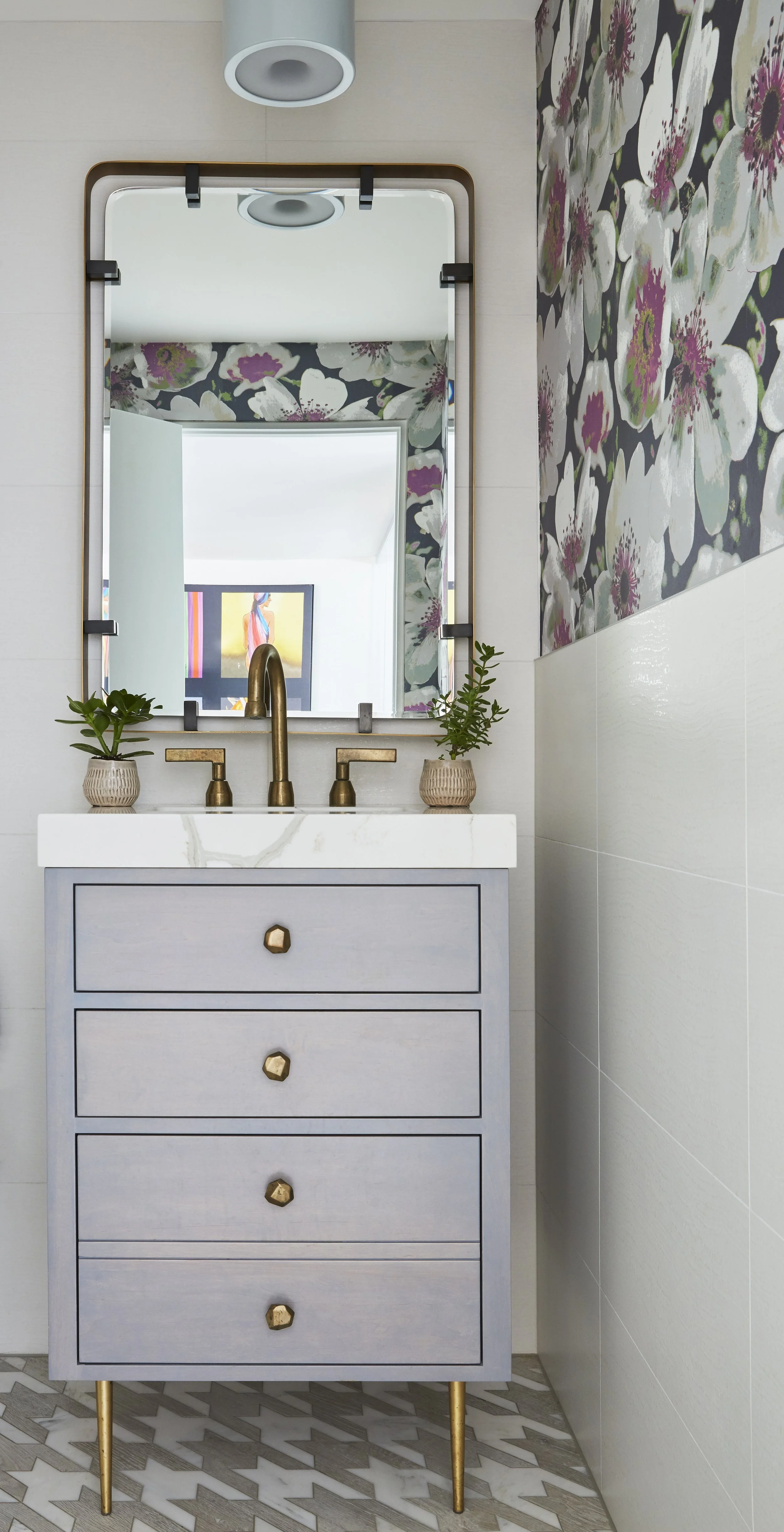 half bath with bold pattern wallpaper and colorful fixtures adds fun