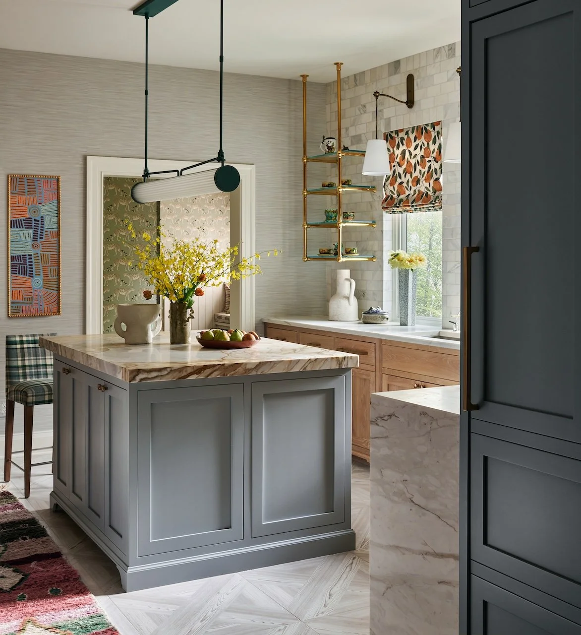 collected kitchen brass glass shelving marble tile backsplash oak cabinets gray island