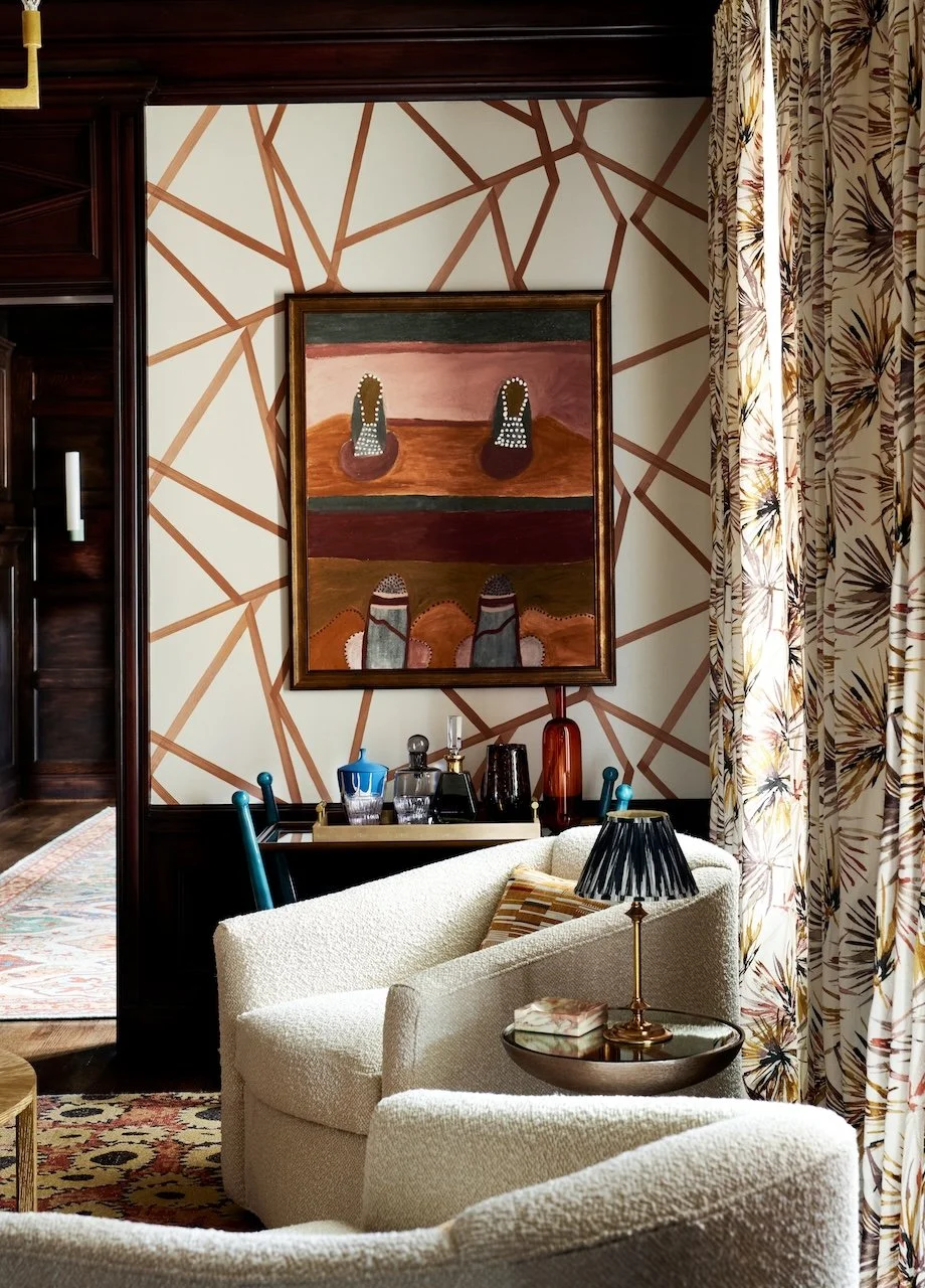 traditional living room patterned drapes boucle chairs layered rugs flow