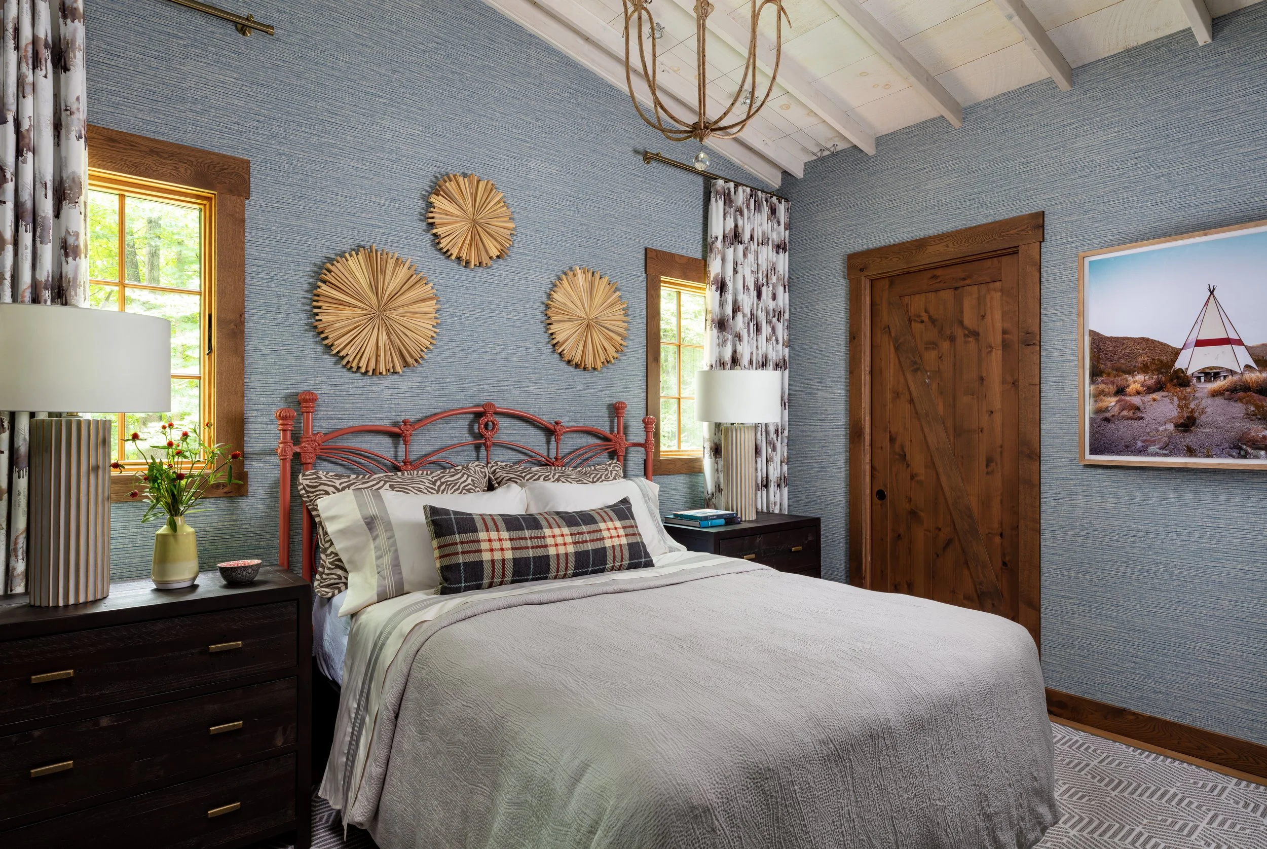 traditional-kids-bedroom-with-painted-rod-iron-bed-and-cozy-bedding-textured-blue-wallpaper-nightstand-lighting-andwood-accents.jpg