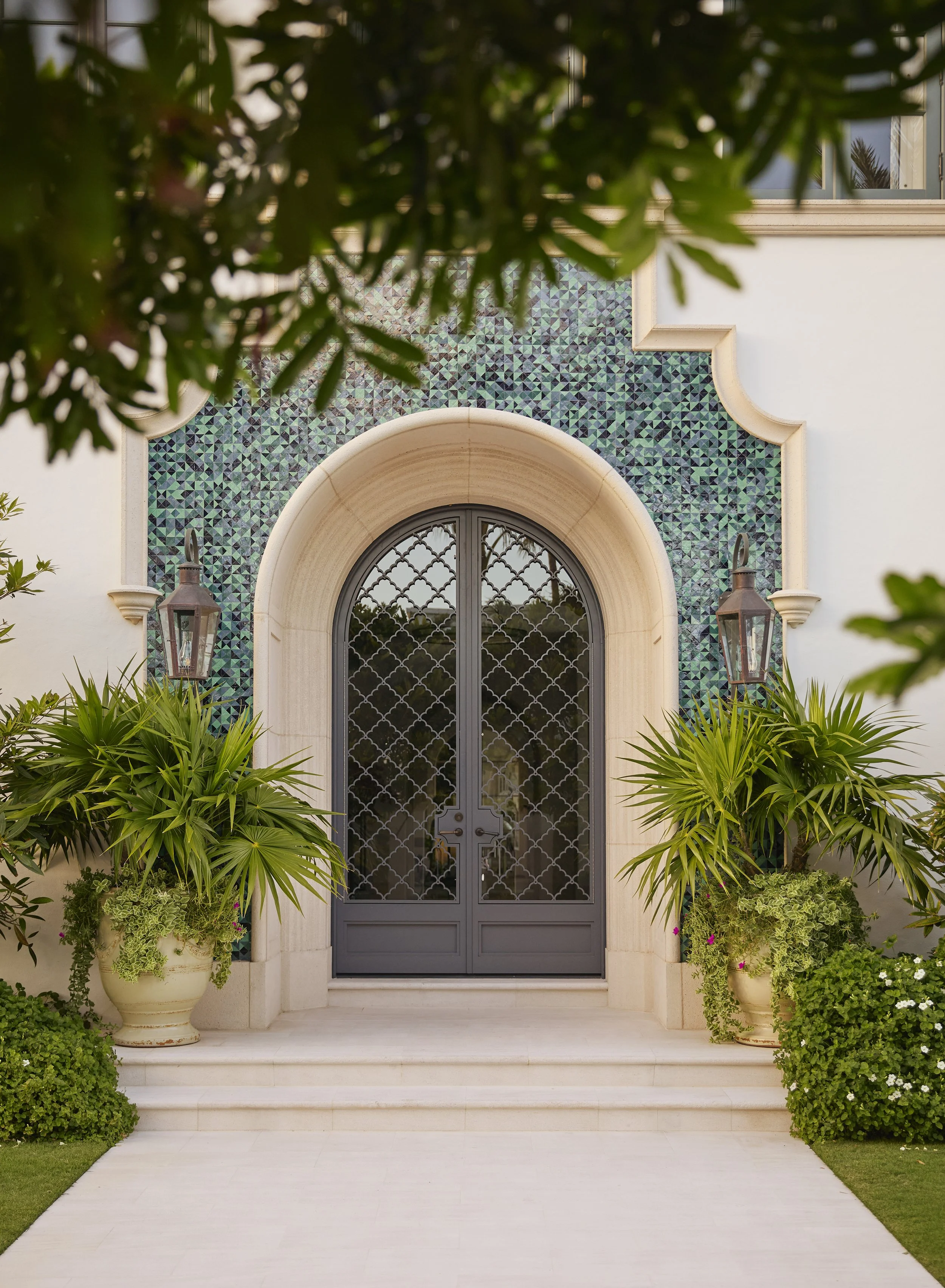 spanish revival mediterranean styled home with teal tiled entrance