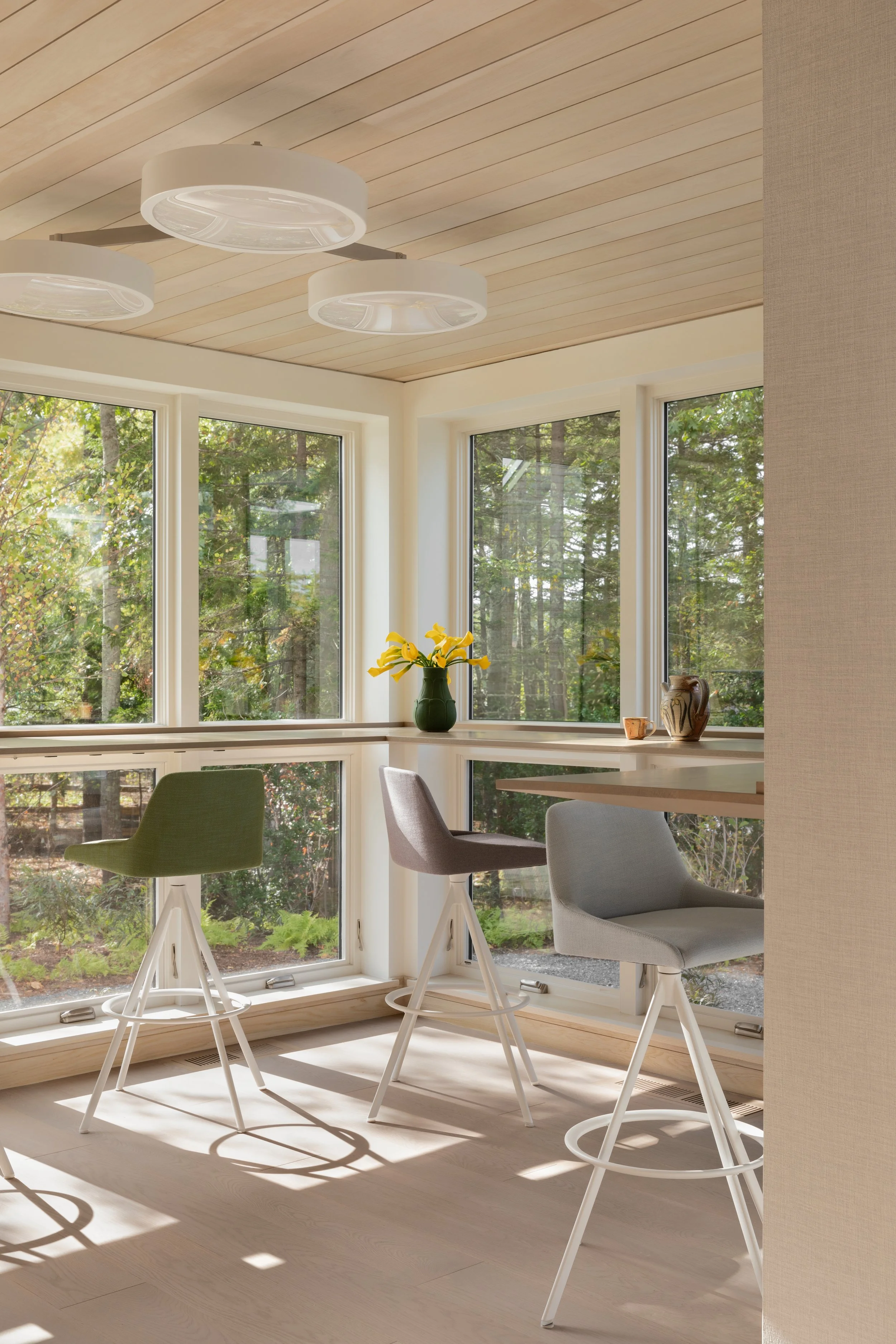 built in table with stools for sunroom with windows