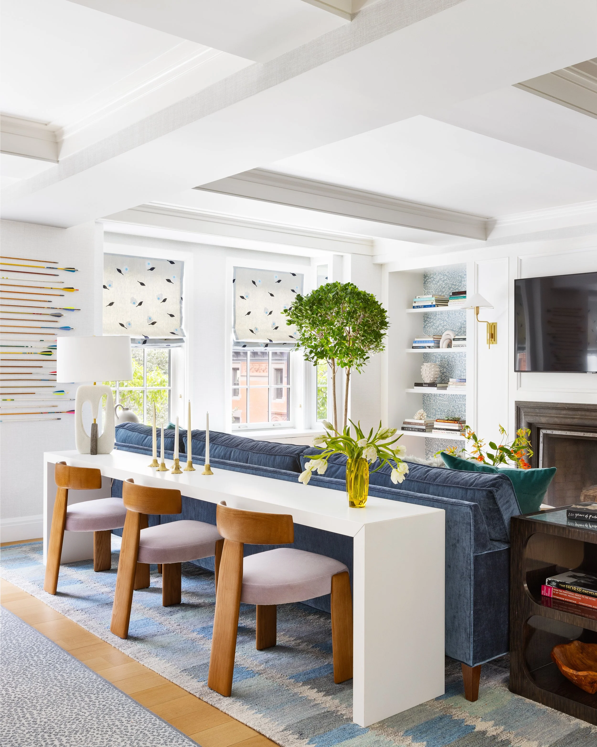 casual family room with console and stools behind sofa for seating