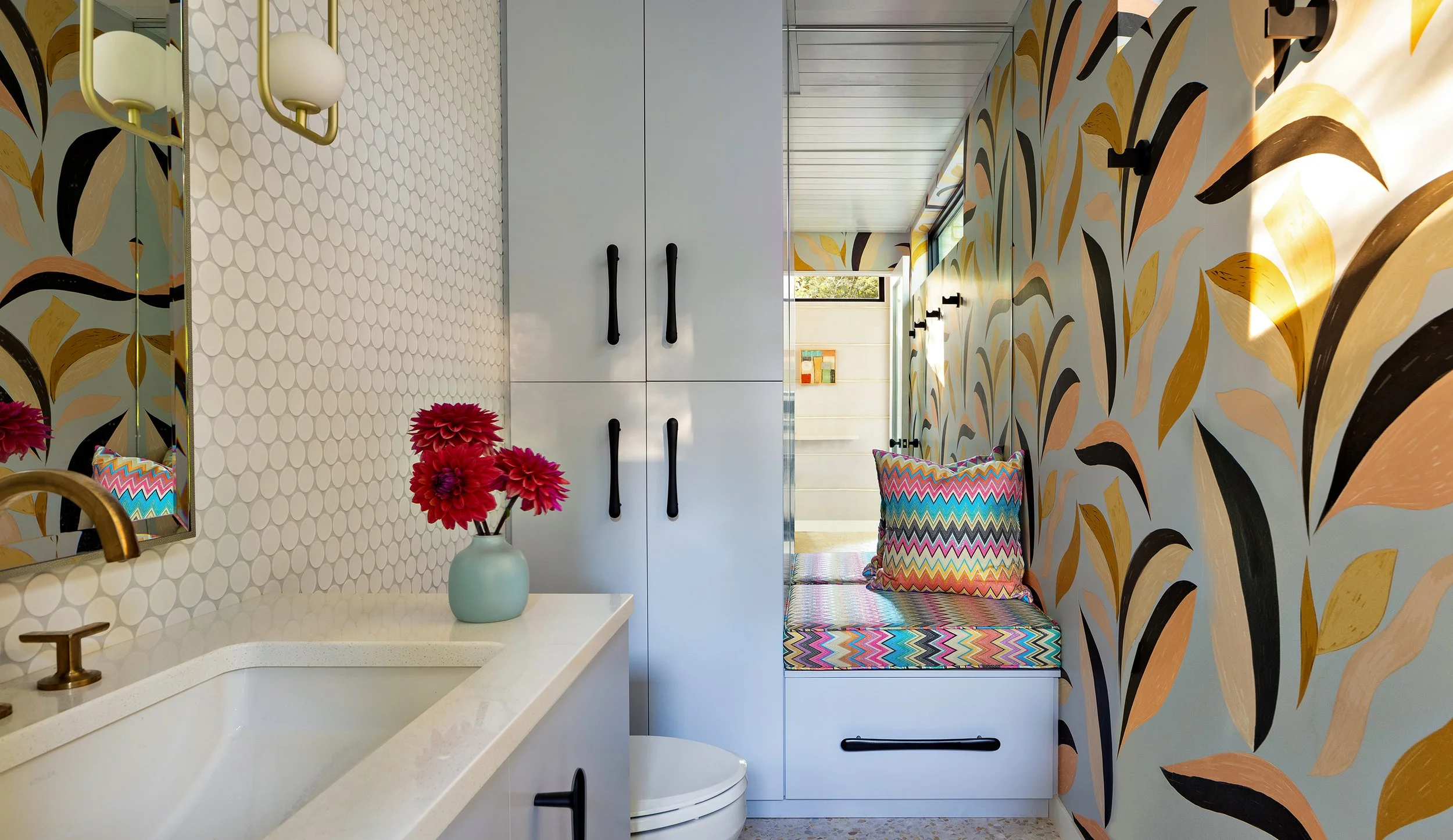 modern bathroom with statement wallpaper white subway tiles and built in cabinets for storage