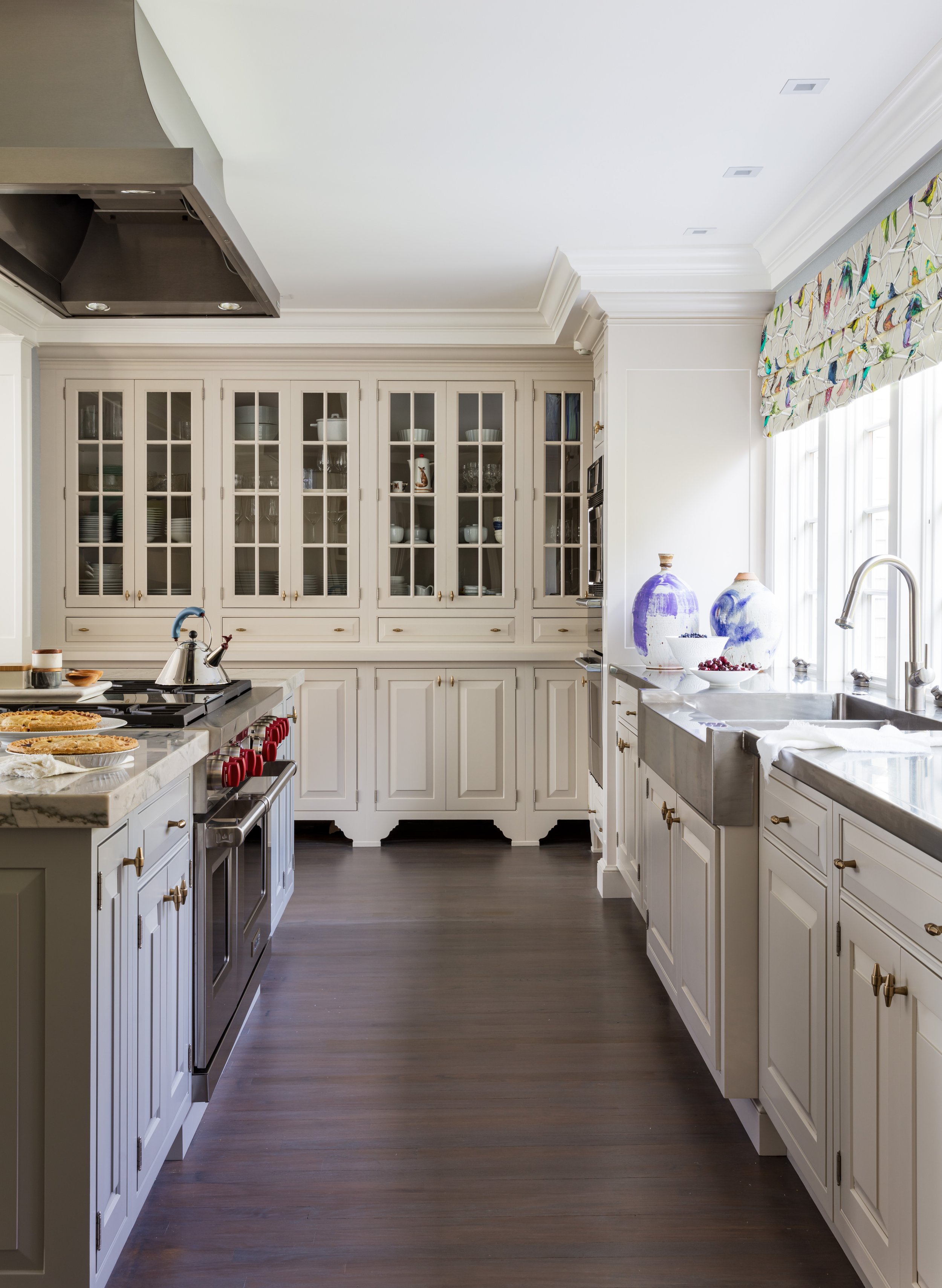 classic kitchen design featuring white glazed cabinets with glass doors, stainless steel appliances, marble countertops, and dark hardwood floors, perfect for modern home renovation