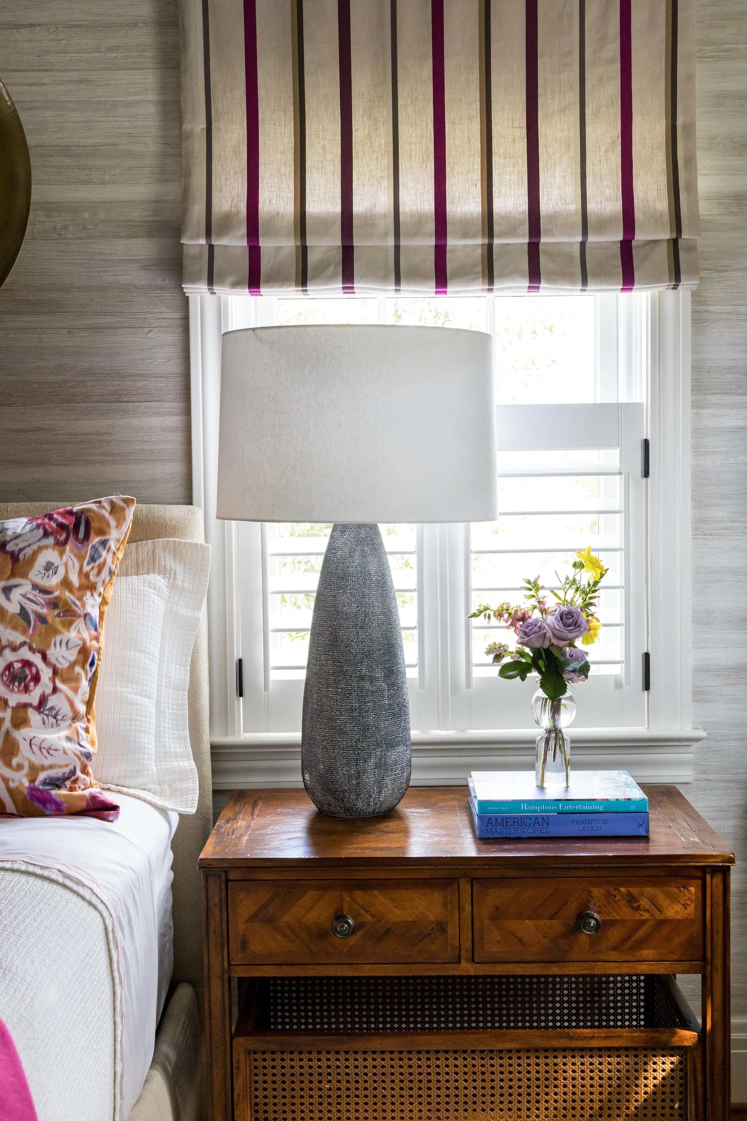 bedroom design details wood nightstand ceramic lamp soft striped roman shade valance