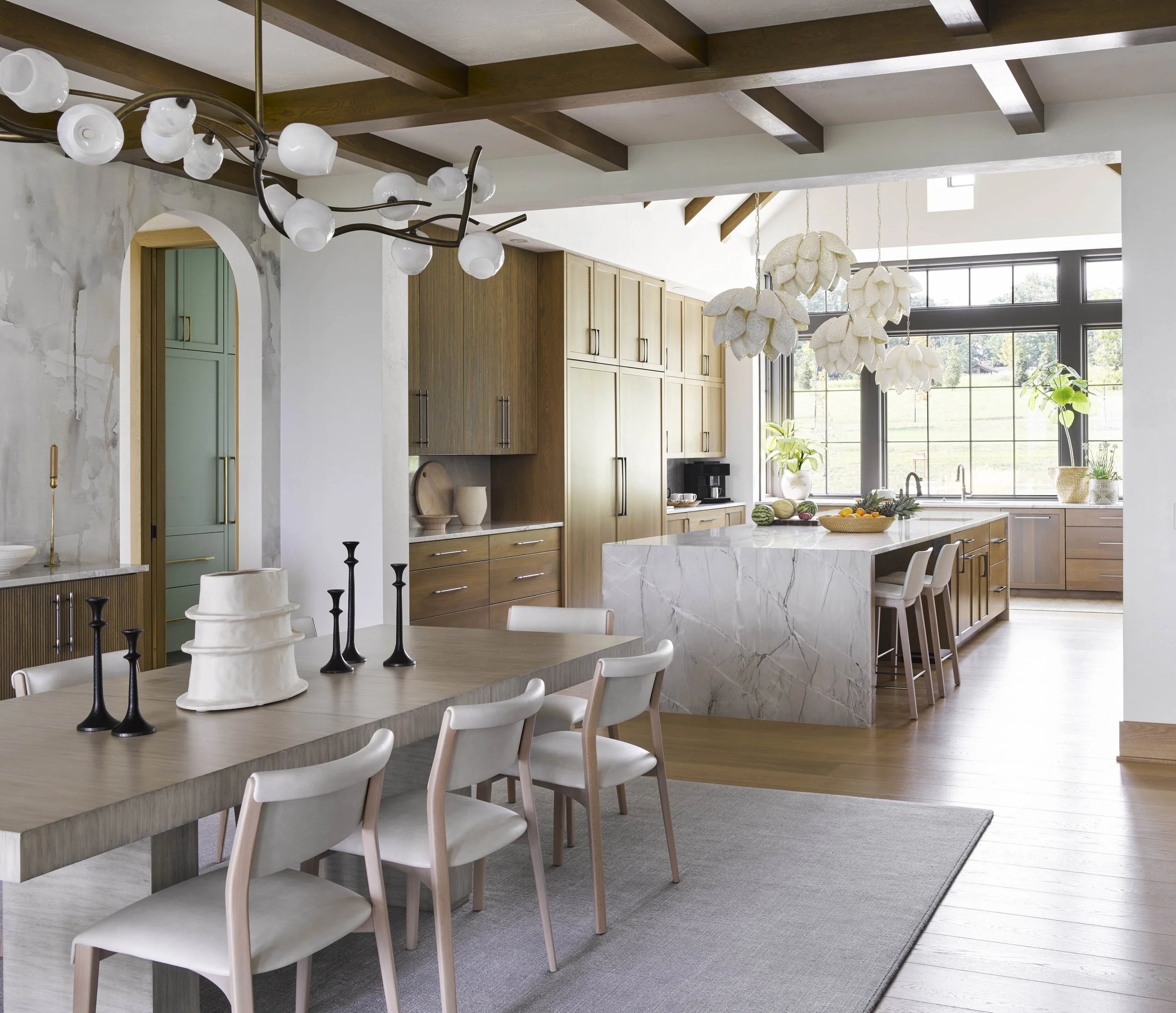 modern-dining-room-open-to-kitchen-with-neutral-tones.jpg