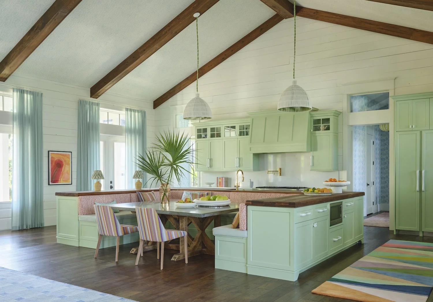 13-florida-kitchen-dining-mint-green-cabinets-vaulted-ceiling-exposed-beams-colorful-rug-coastal-design.jpg