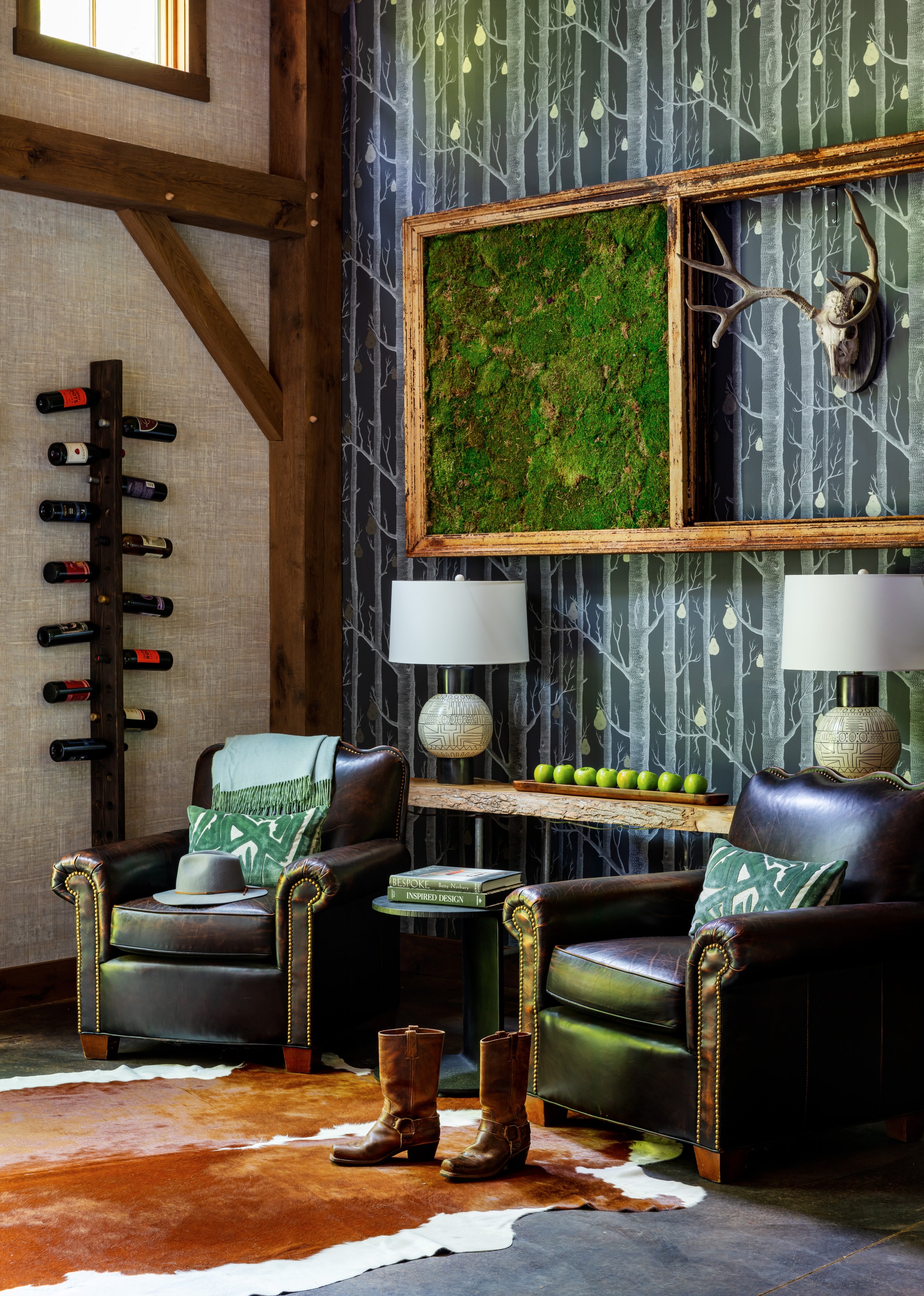 rustic‑luxury‑living‑room‑design‑with‑leather‑armchairs‑green‑moss‑art‑wall‑accent‑wood‑beams‑wine‑rack-and-tree-wallpaper.jpg