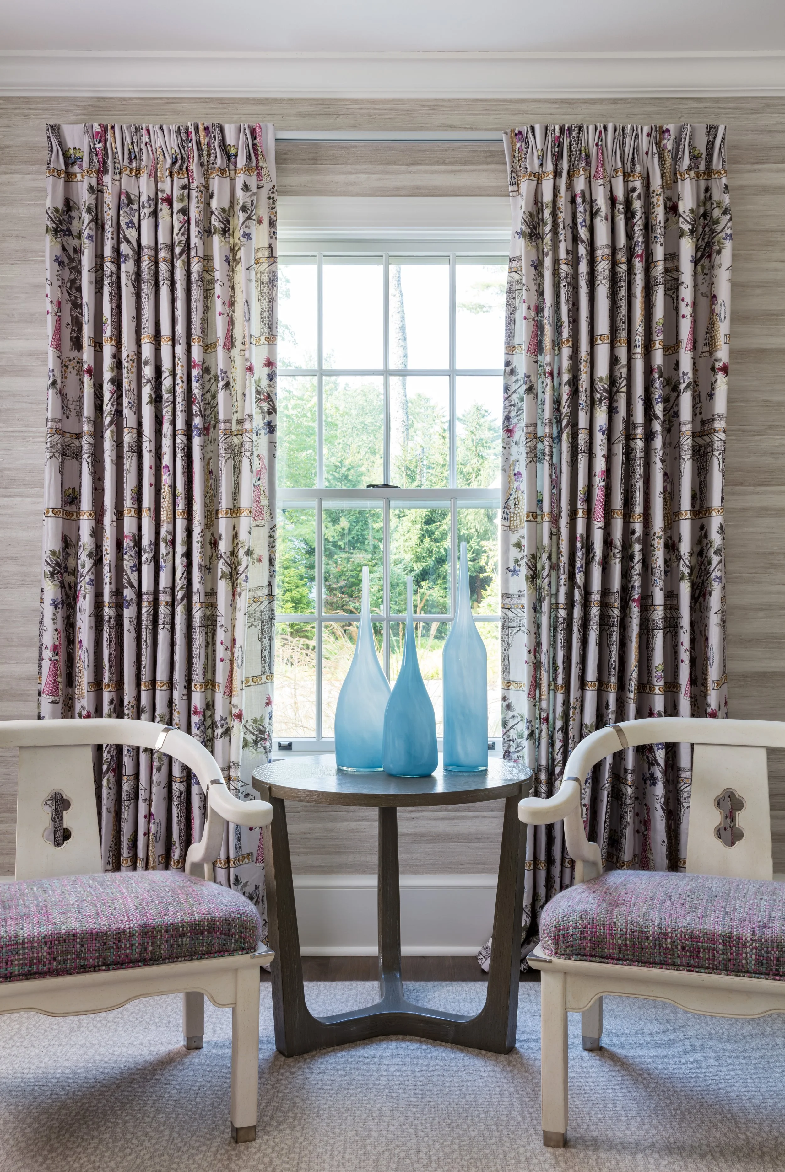 cozy window nook with two chairs round table floral patterned drapery textured wallpaper