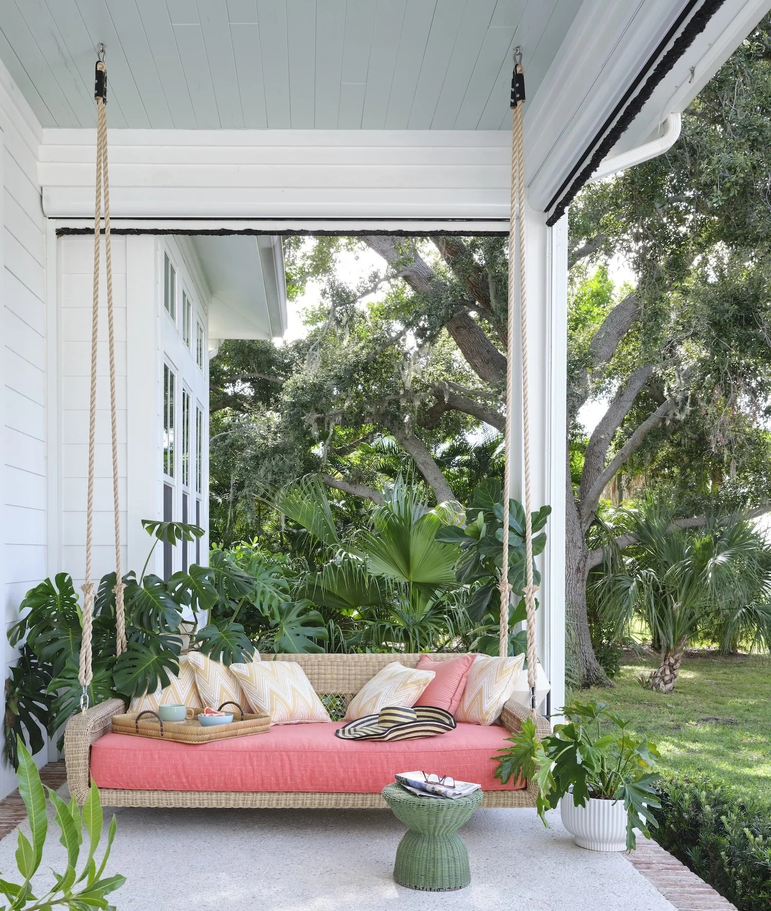 52-wicker-porch-swing-coral-cushion-tropical-patio-outdoor-living-lush-greenery-relaxed-florida-style.jpg