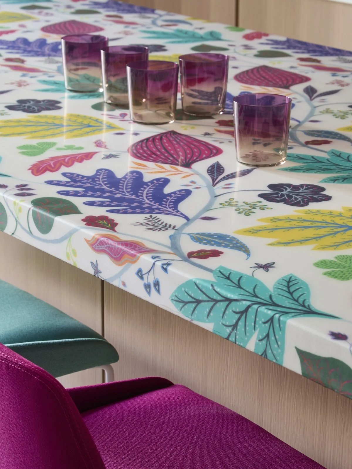 Closeup custom gameroom island with colorful botanical leaf mosaic countertop, purple glasses, bright stools by Betsy Wentz interior design