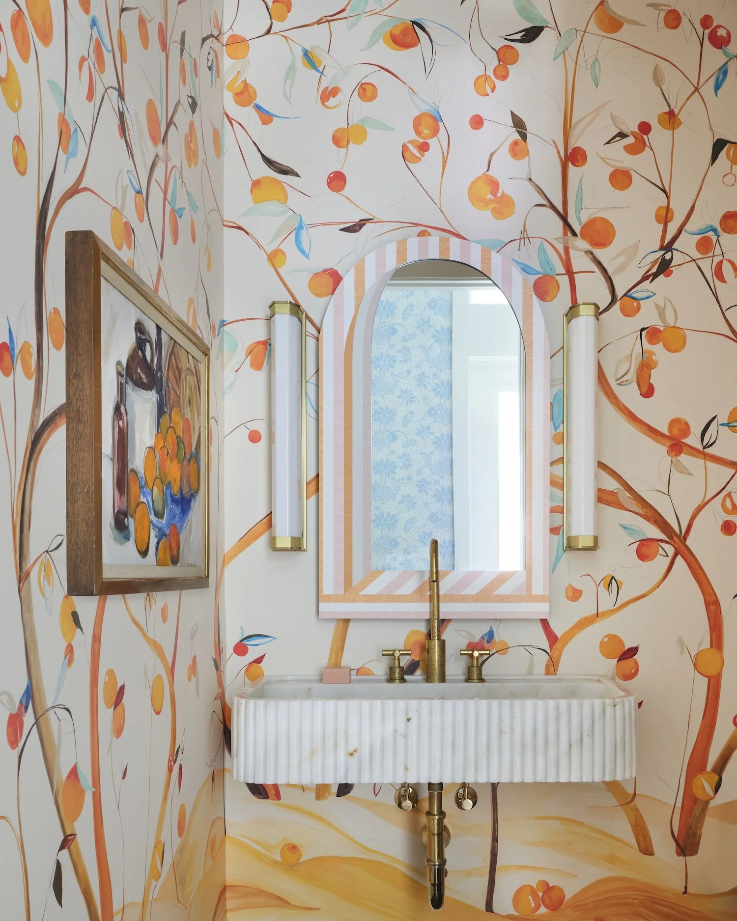 19-whimsical-powder-room-orange-citrus-tree-wallpaper-fluted-marble-sink-striped-mirror-brass-accents.jpg