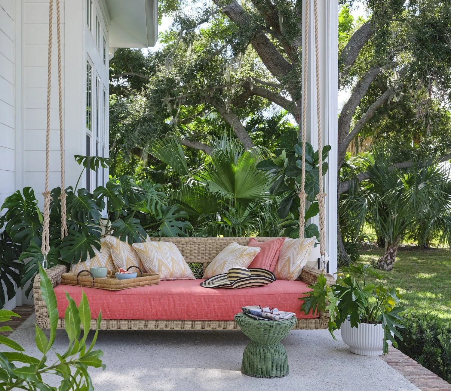 53-wicker-porch-swing-coral-cushion-tropical-patio-outdoor-living-greenery-relaxed-florida-style.jpg