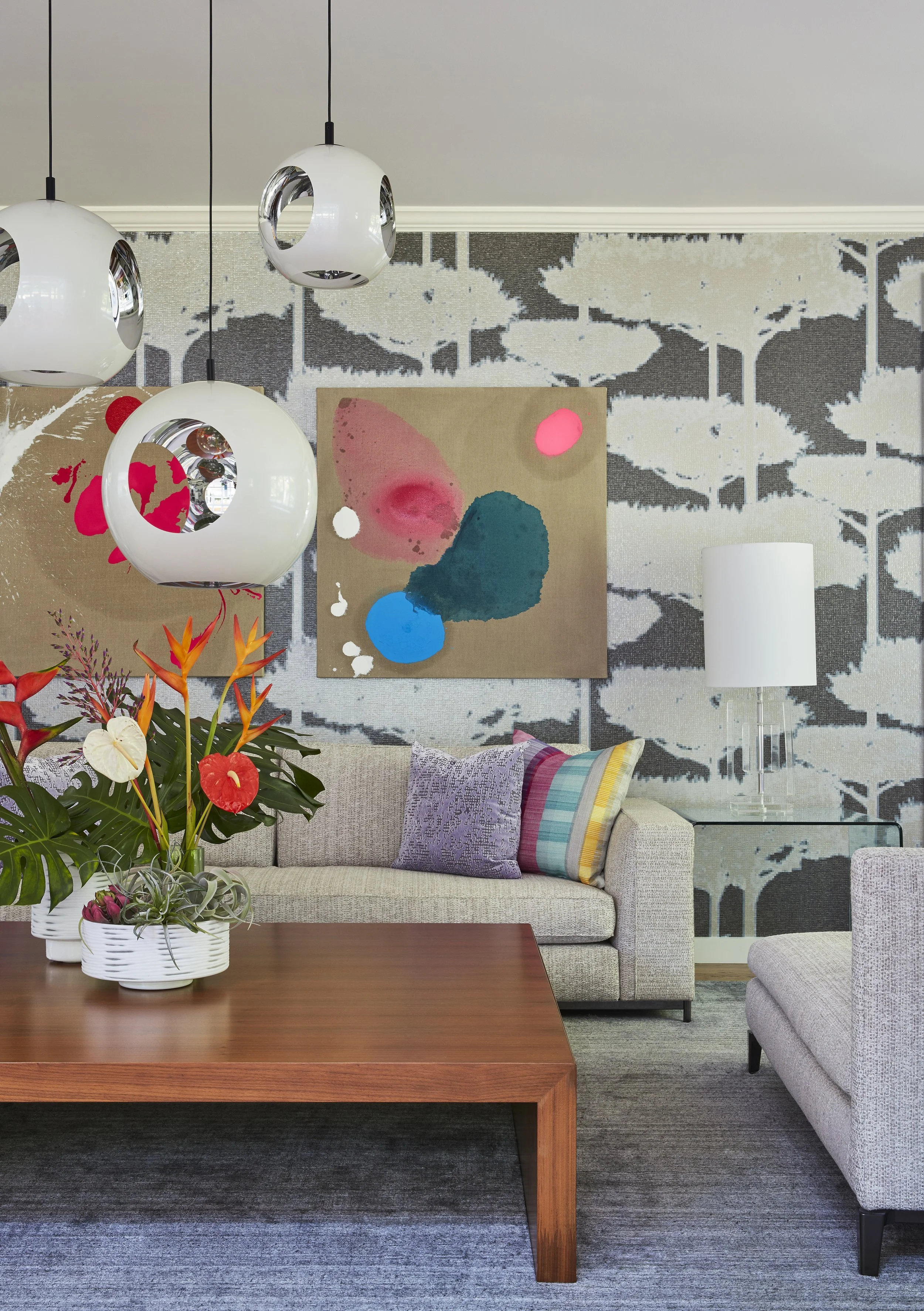 modern living room design with low coffee table neutral sofas globe pendant lights and gray abstract wallpaper