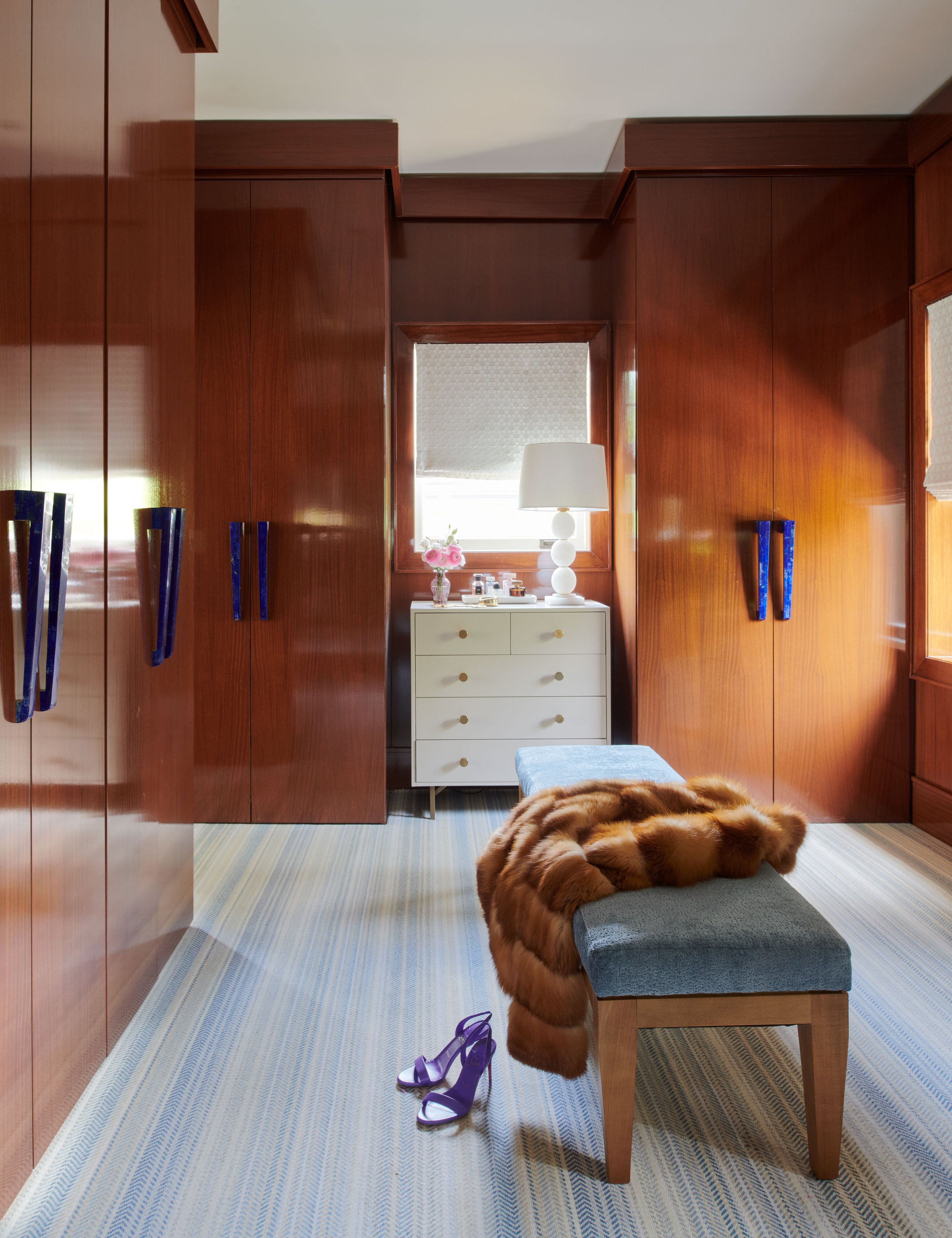 elegant-primary-bedroom-closet-with-bench-seating.jpg