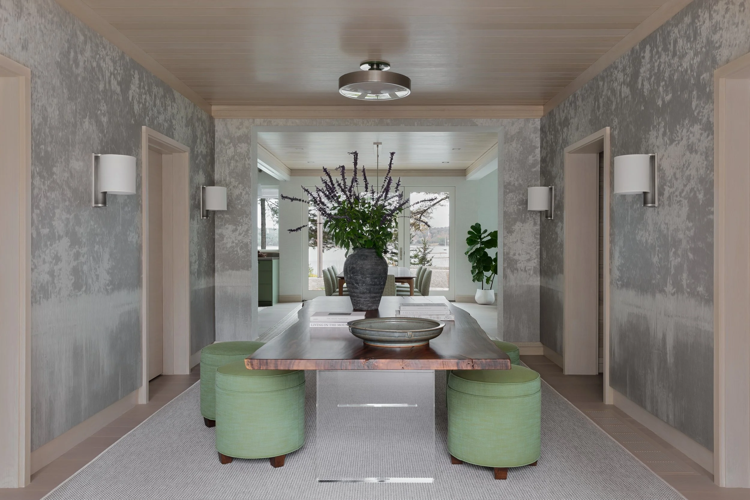 entry design with textured grey wallpaper live edge table and green stools