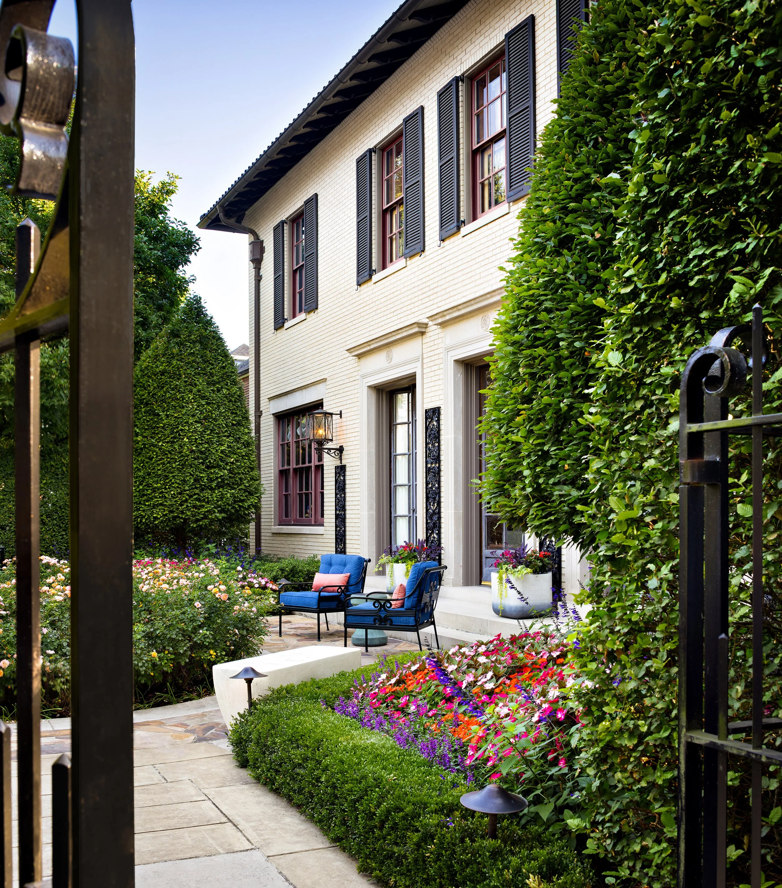 stately house exterior with rose gardens and outdoor seating